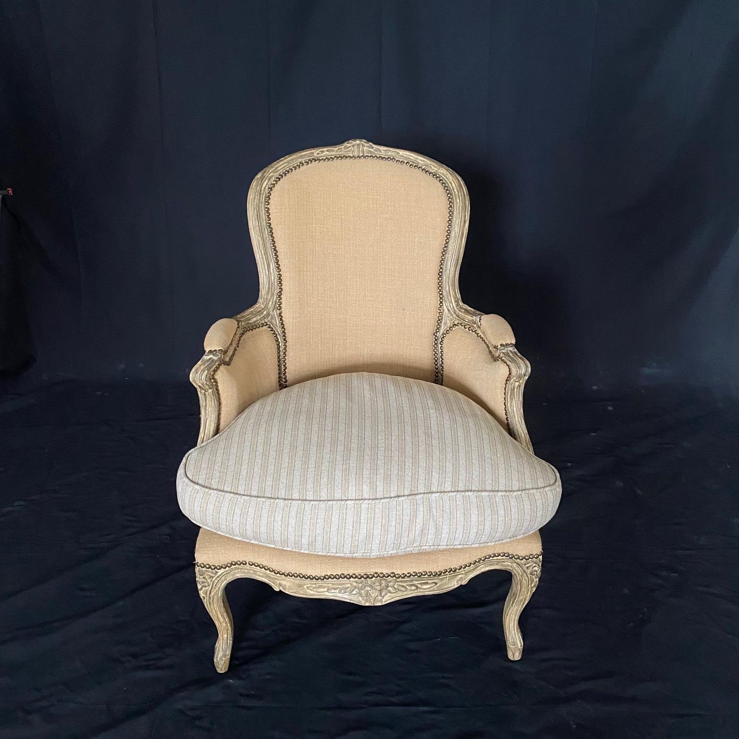 Vintage French Louis XV style Arhaus Charlotte Collection bergere arm chair featuring lovely and immaculate upholstery and classic carved wood frame and pretty windowpane back. Beautiful contrasting original seat cushion. Measure: Arm height