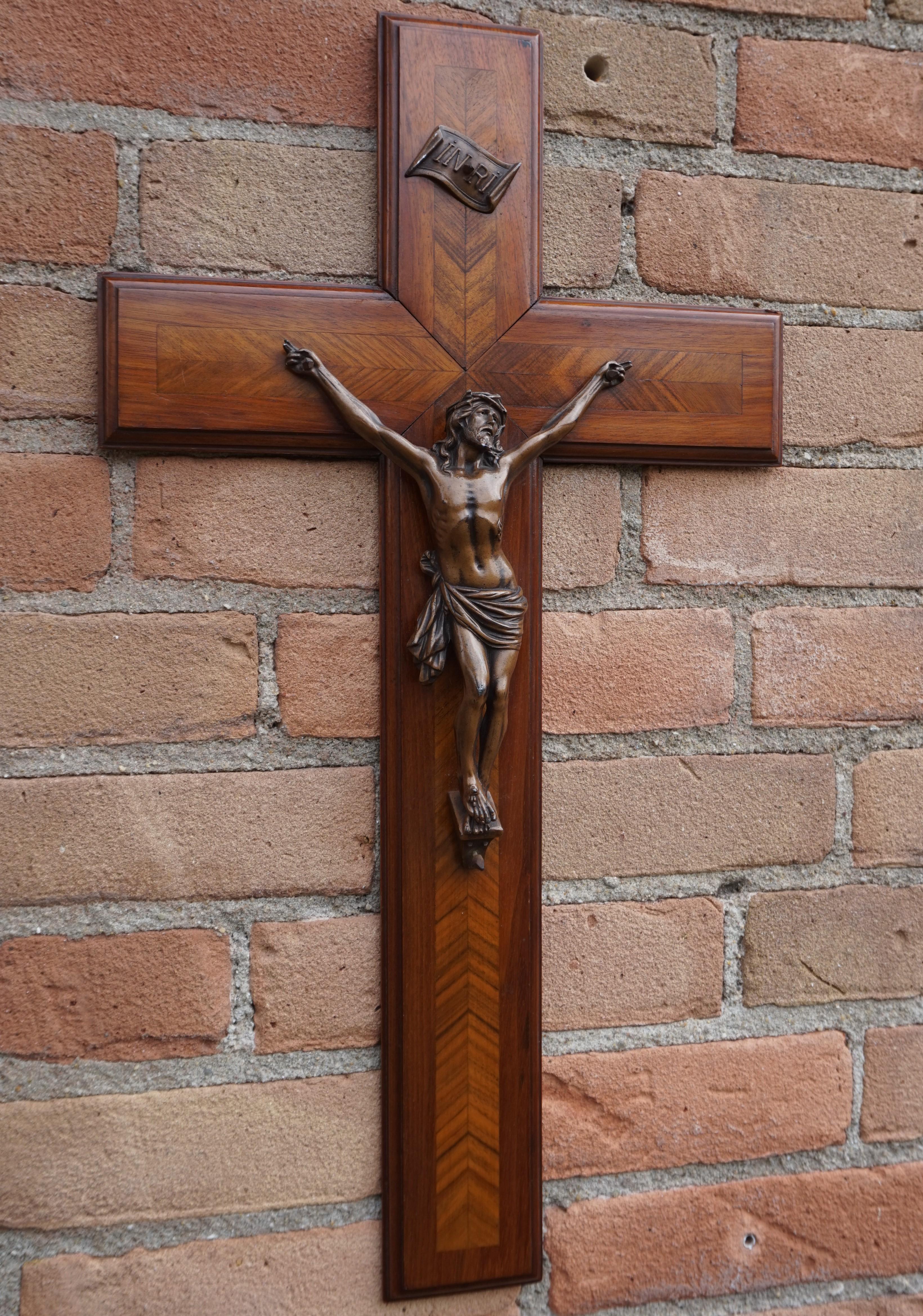 Exceptional wooden cross with a highly detailed corpus with maker's marks.

This handcrafted work of religious art from early 20th century France, is a real eyecatcher. The combination of the warm colors of the beautifully inlaid, wooden cross and