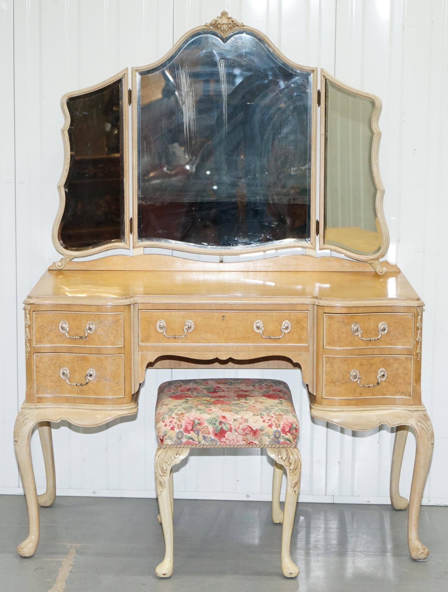 We are delighted to offer for sale this lovely hand made in England vintage 1930s Maple & Co light burr walnut dressing table with tri fold mirrors and original matching stool

We have cleaned waxed and polished it from top to bottom, the frame is