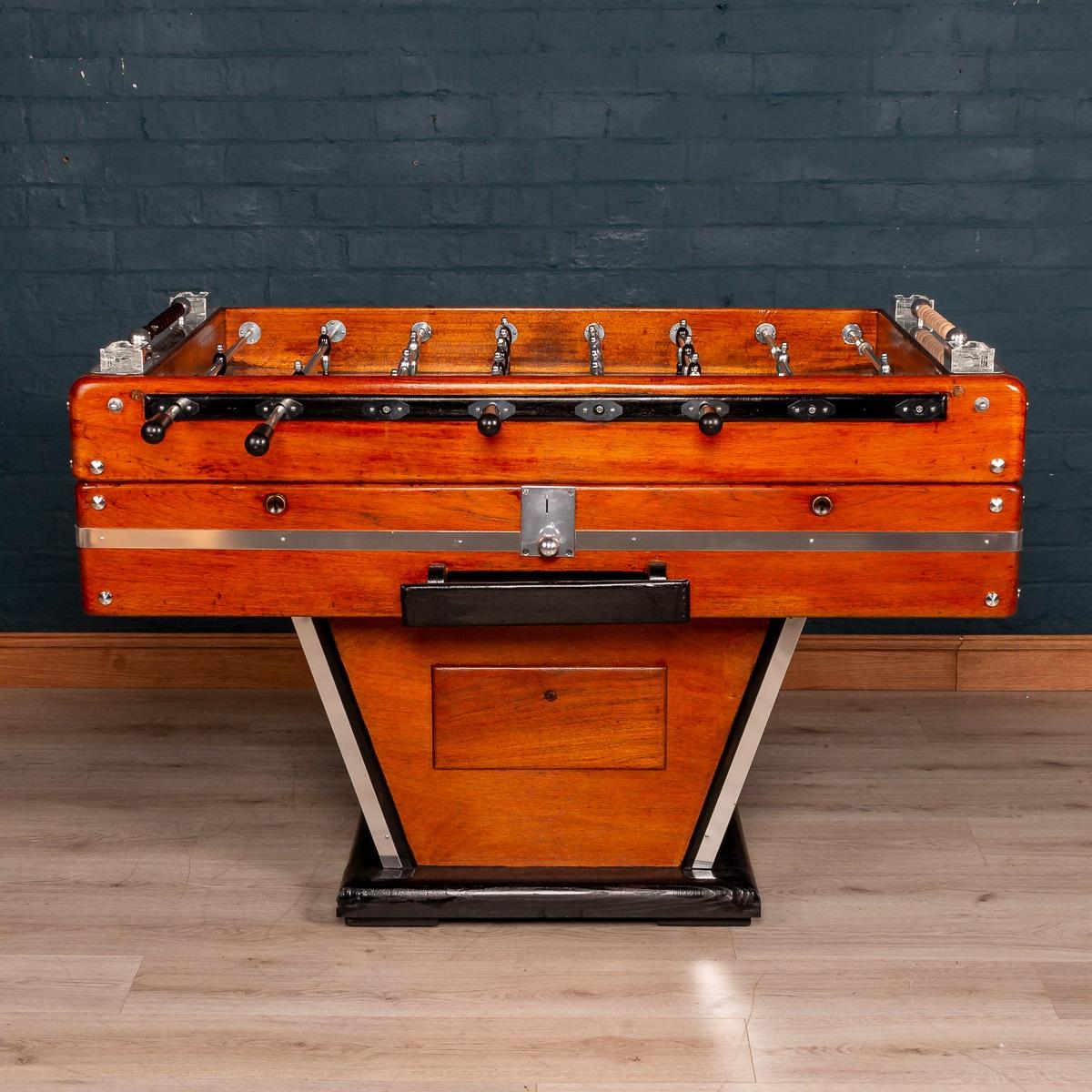 Beautiful and fully restored French table football game, mid-20th century. Painted and varnished wood and chromium plated and other metals, each side with four wooden-handled rods, and mounted with Art Deco style glass ashtrays, the footballers of