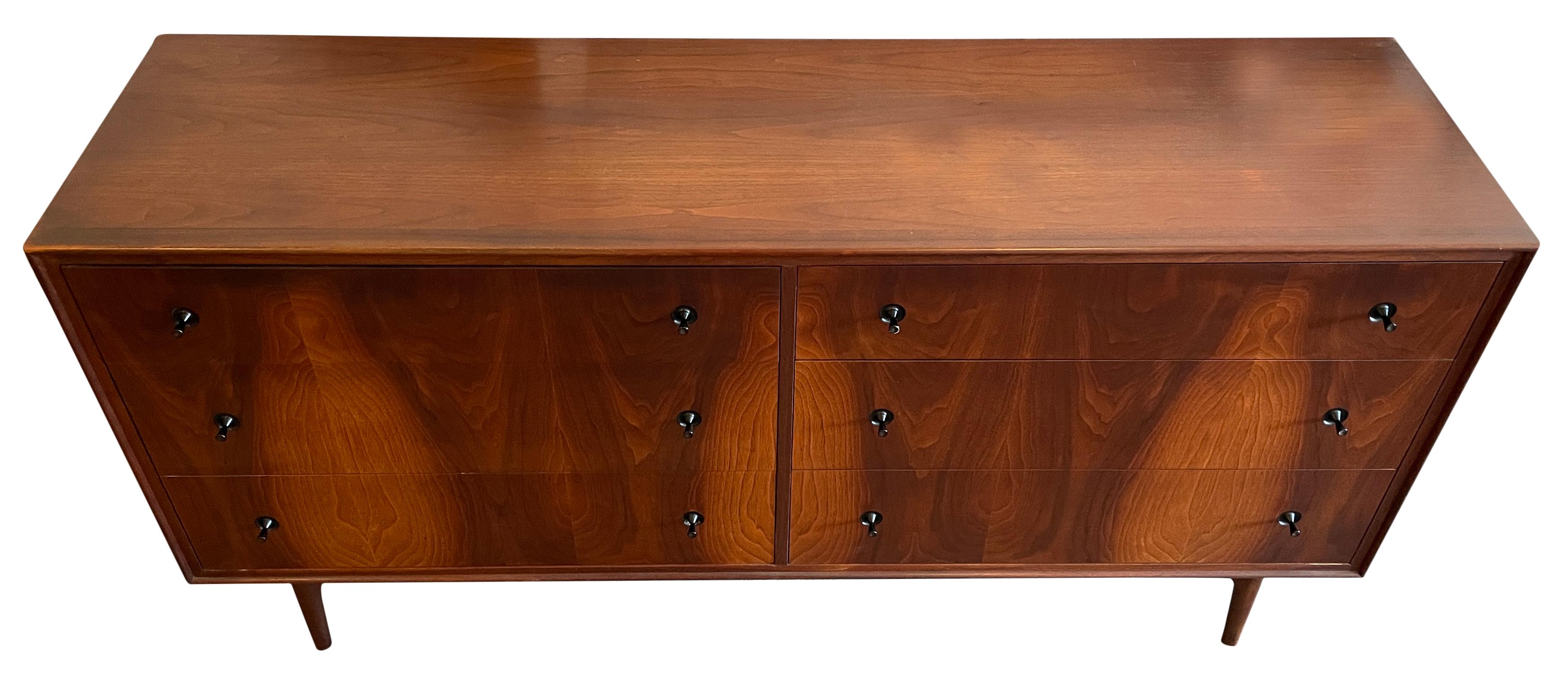 Stunning Mid-Century Modern 6 drawer walnut dresser veneer front. Beautiful grain American made dresser solid walnut and veneers. Clean inside and out - all drawers slide smooth. Black tapered knobs and sits on a solid walnut sculpted base. Very