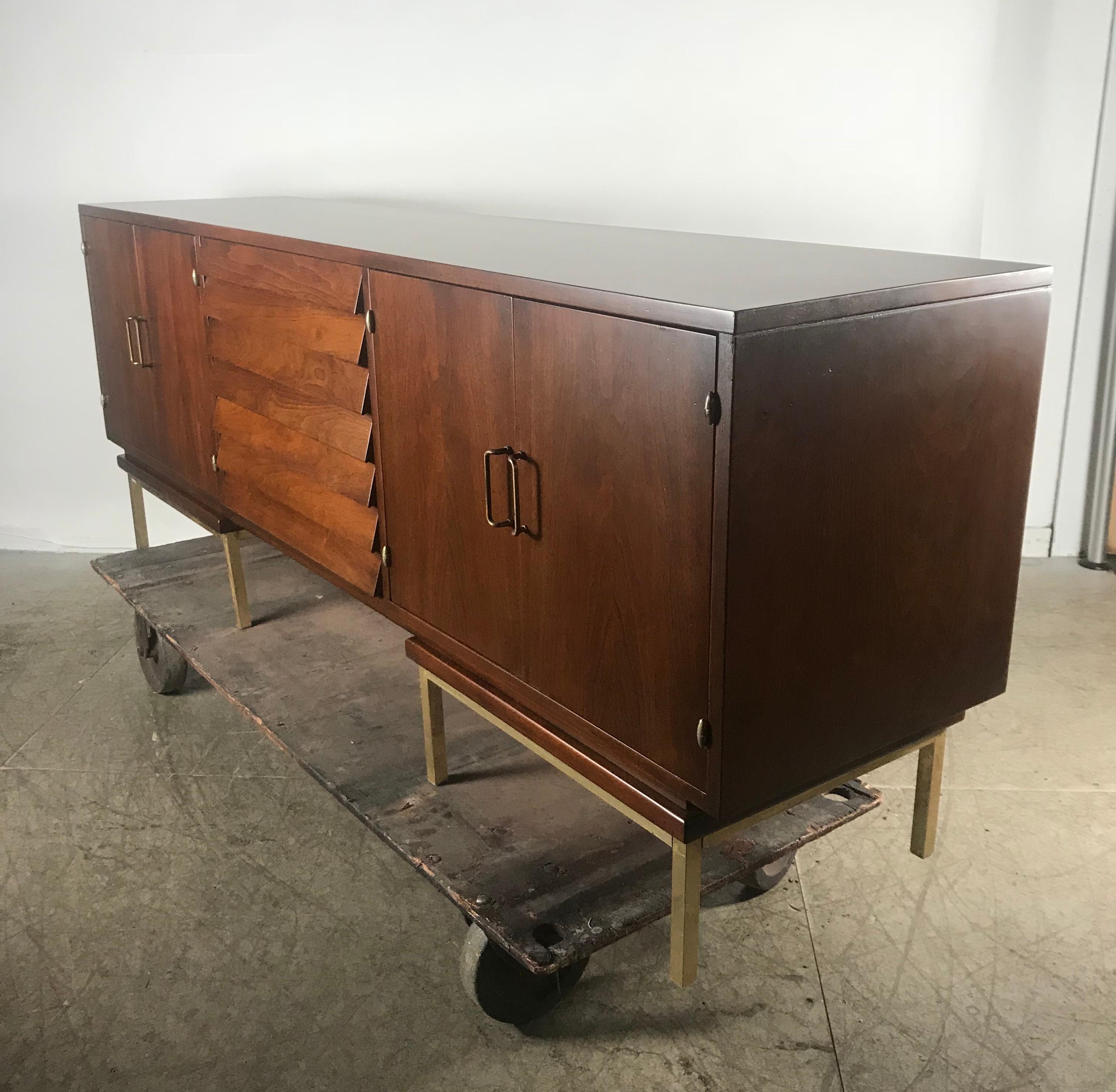 Stunning Mid-Century Modern walnut and brass credenza or sideboard by American of Martinsville. Professionally restored. Superior quality and construction, hand delivery avail to New York City or anywhere en route from Buffalo NY.