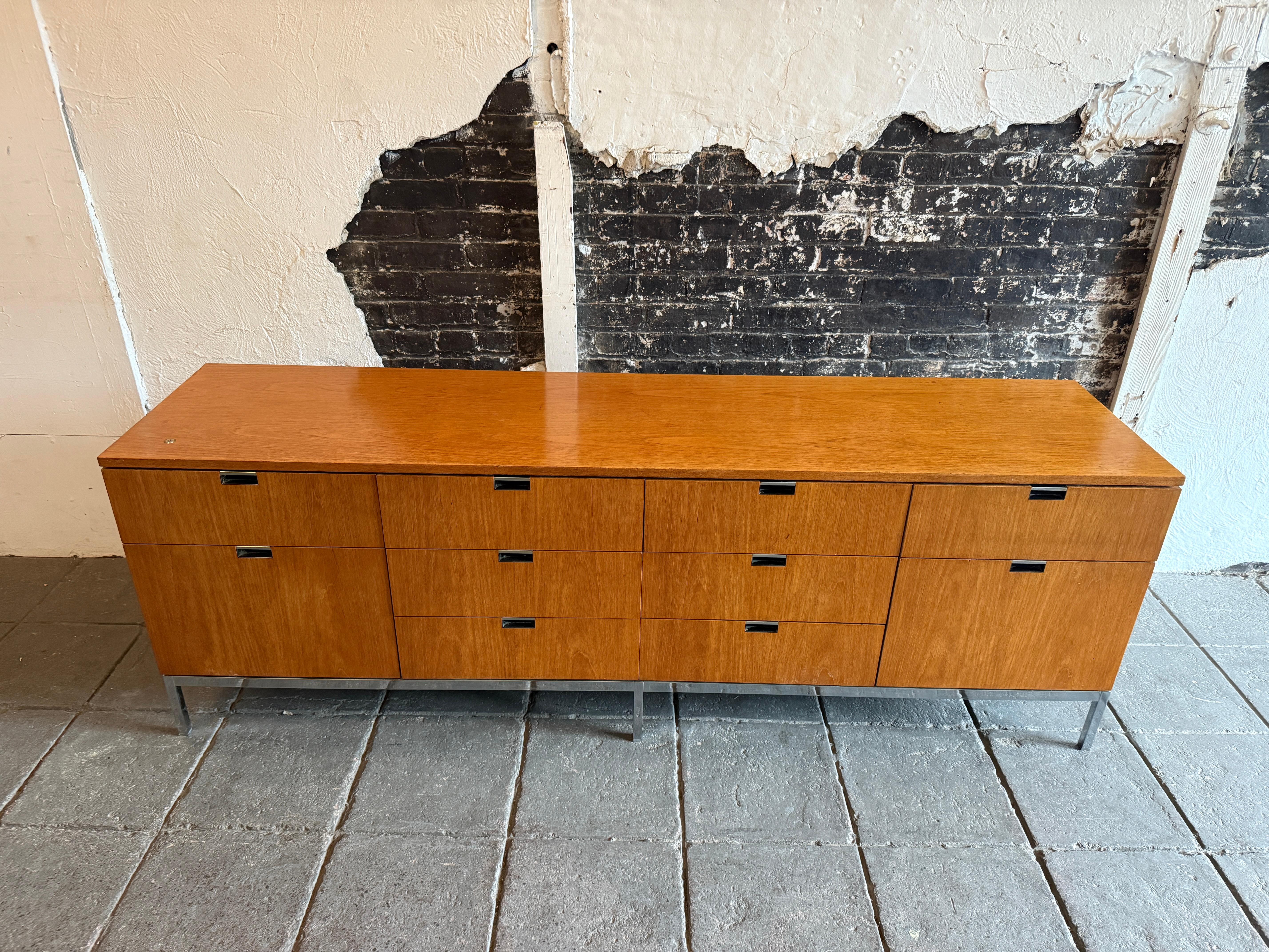Beautiful Mid Century Florence knoll Oak credenza. Featuring (10) drawers on a chrome square base that have adjustable leveling feet with chrome pull handles. Sleek and ready for use for your home or office as a Credenza or Sideboard for your