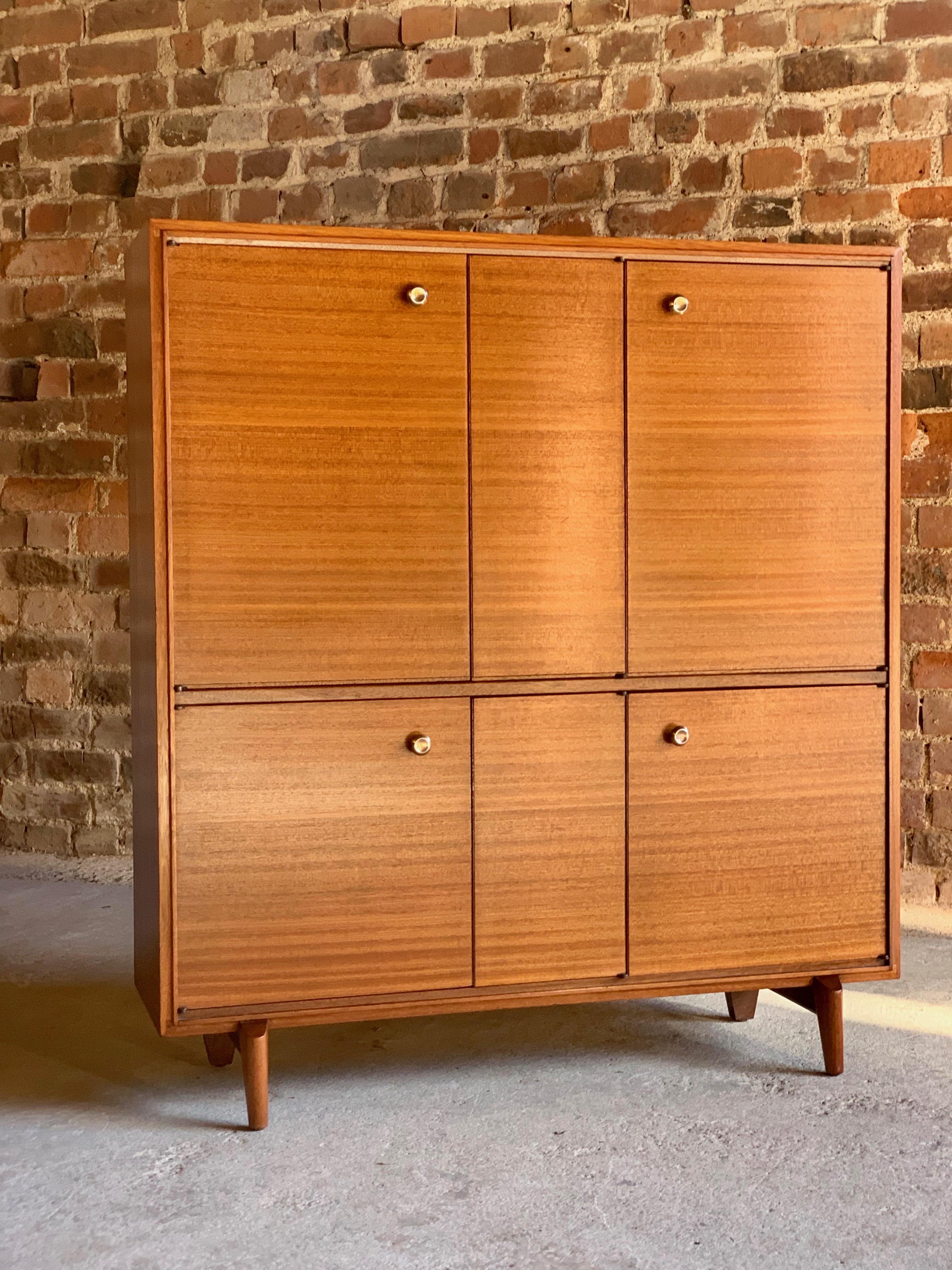 Stunning midcentury teak drinks cabinet sideboard, circa 1950s. 

A fabulous midcentury Teak drinks side cabinet circa 1950s, the tall and narrow cabinet enclosed by two pairs of double doors to the left side with interior shelves and two single