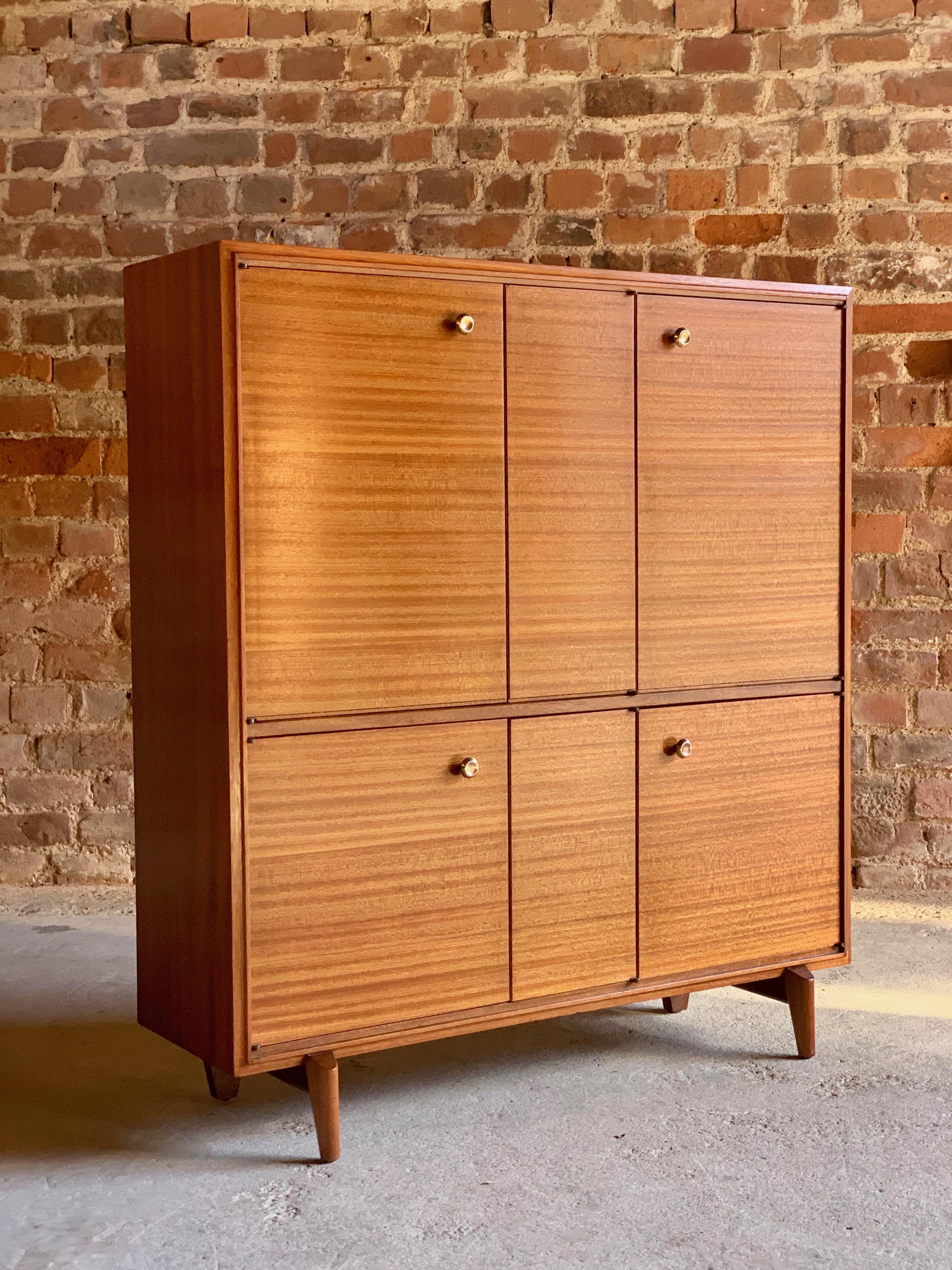 Stunning midcentury teak drinks cabinet sideboard, circa 1950s.

A fabulous midcentury teak drinks side cabinet, circa 1950s, the tall and narrow cabinet enclosed by two pairs of double doors to the left side with interior shelves and two single