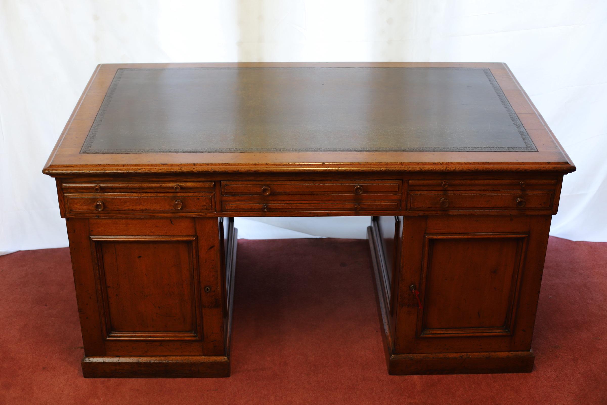 We delight to offer for sale this stunning restored mid Victorian twin partners desk , the moulded top inset with tooled green leather above an arrangement of four frieze drawers and six leather-lined slides, the two pedestals with opposing cupboard