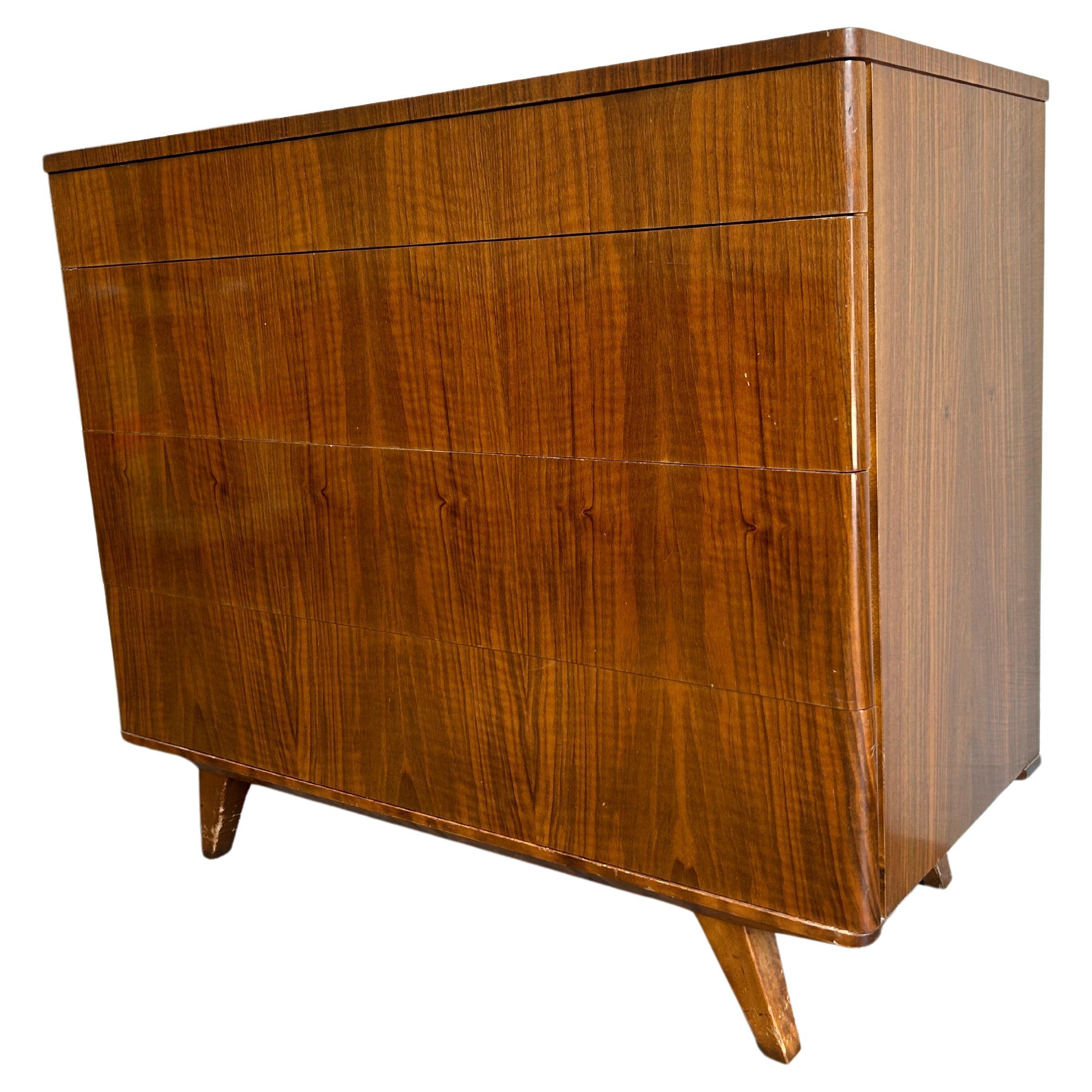 Stunning early deco mid century 4 drawer teak veneer dresser made in Sweden. Beautiful early deco style mid century dresser. Beautiful blonde birch wood drawer construction all clean and slide smooth. Great design with a stunning exotic teak veneer