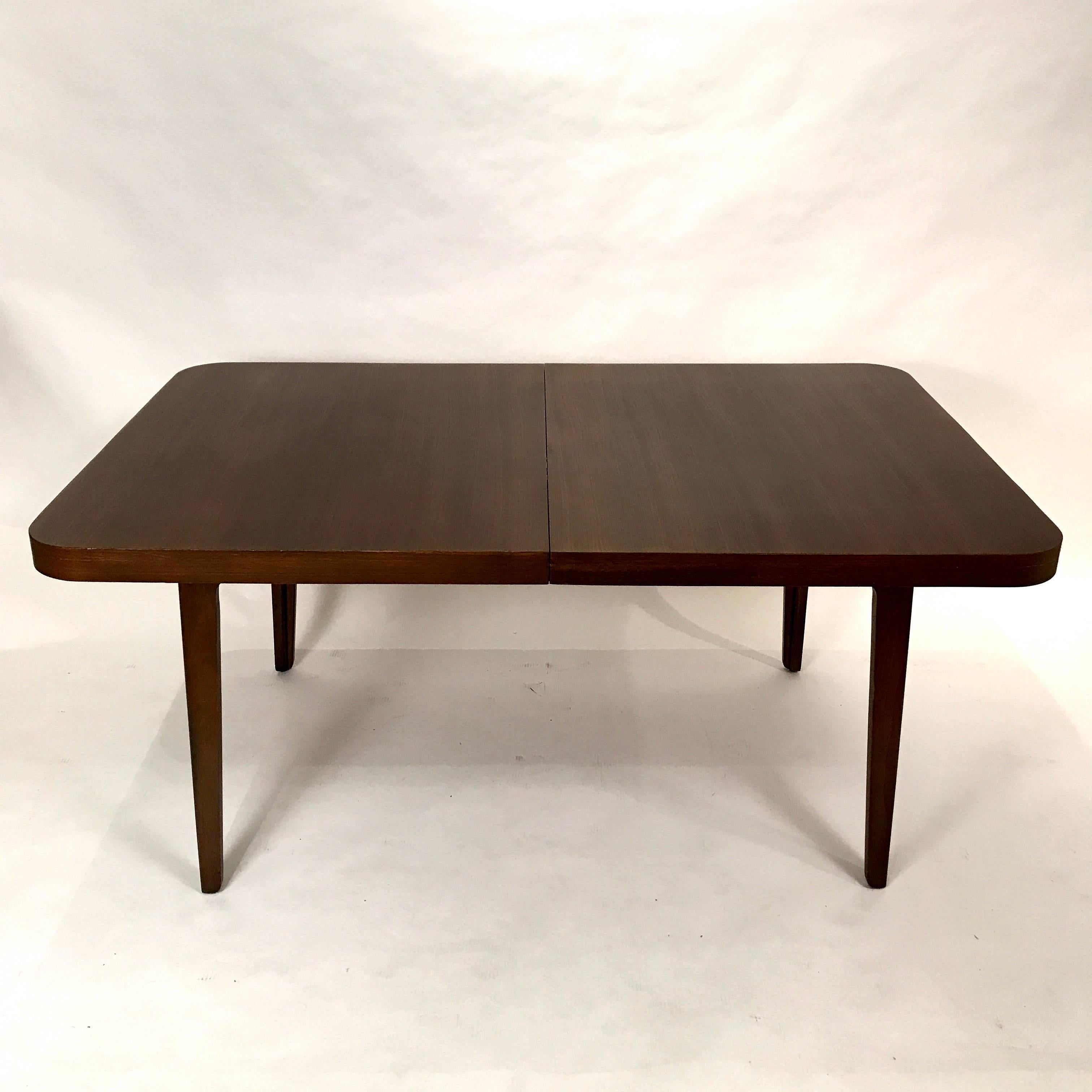 Beautiful original Edward Wormley for Drexel extension dining table. This piece retains it's original finish and is fantastic condition with two matching extension leaves. The shape is classic yet modern in design and works well with any number of