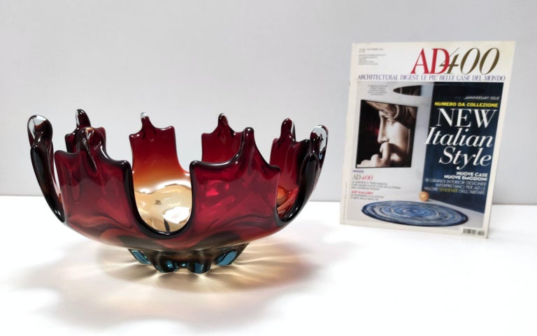 This bowl/centerpiece is made in red, orange and yellow Murano glass, a beautiful combination that creates a flame effect. 
It is a vintage piece, therefore it might show slight traces of use, but it can be considered as in perfect original