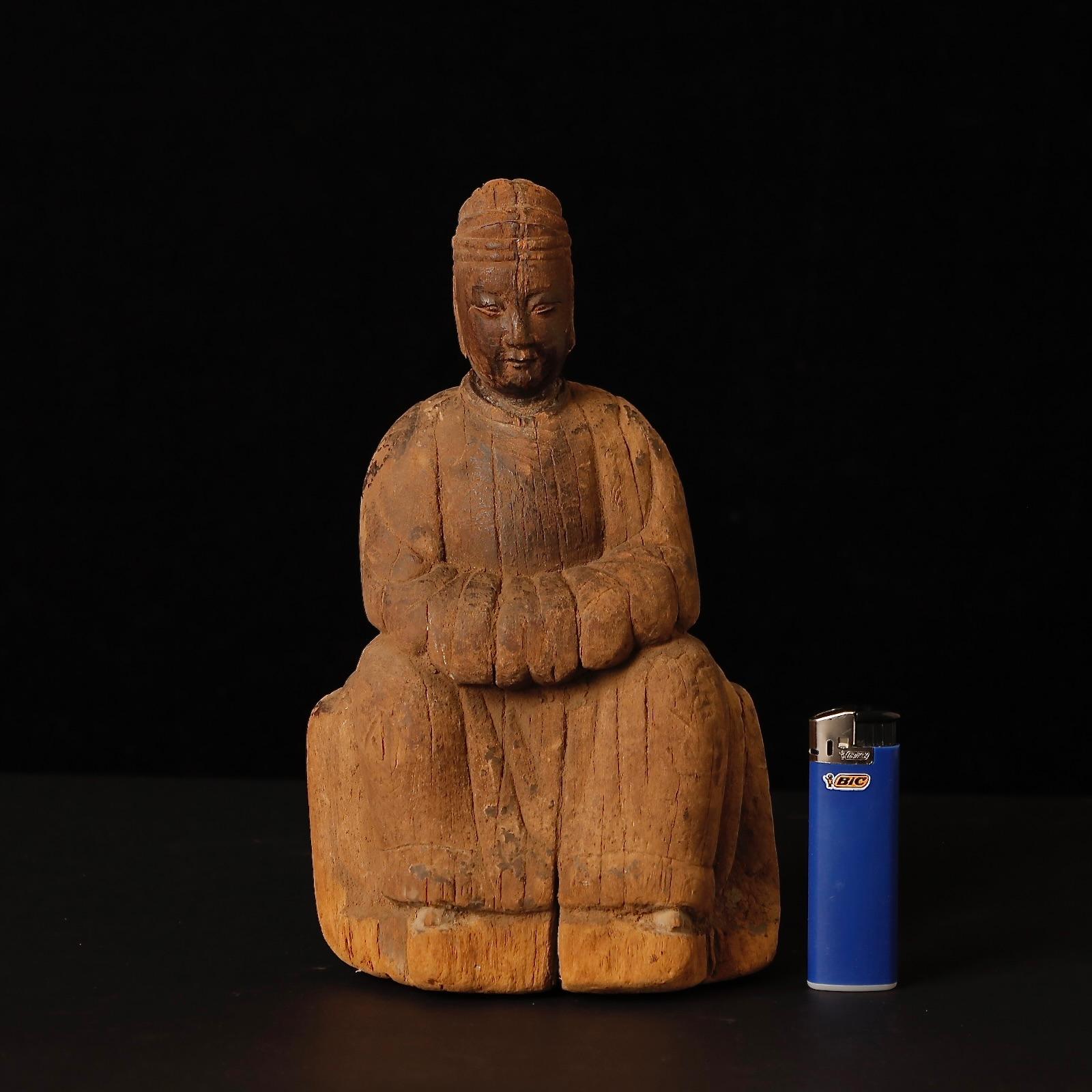 A rare and evocative wooden sculpture of a male deity, dating to the Ming dynasty (14th–17th century), China. The figure’s calm expression and dignified posture reflect the spiritual authority and artistic refinement of the period.

The surface is
