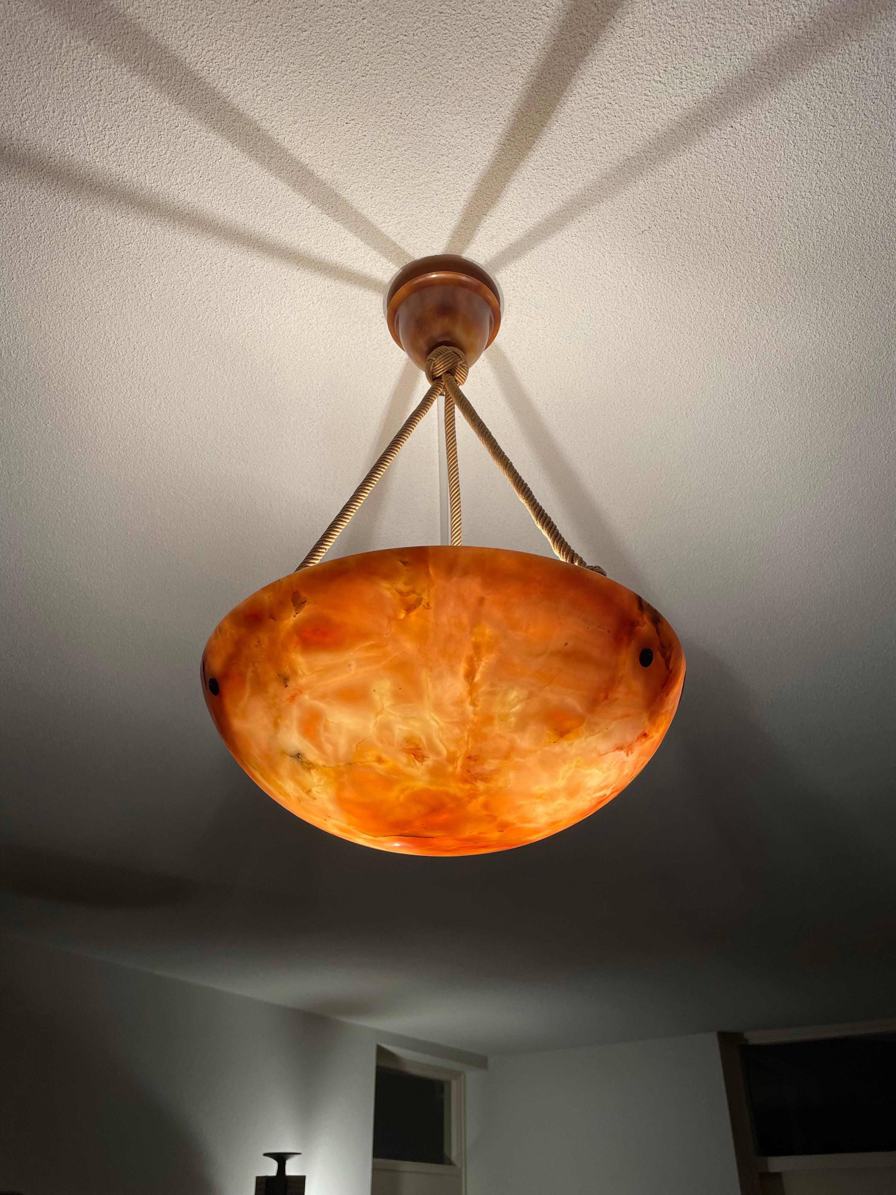 Timeless design and warmest color alabaster light with matching canopy.

If you are looking for a truly beautiful, great quality and all original alabaster pendant then this striking specimen could be the one or you. This regular size, but deep for