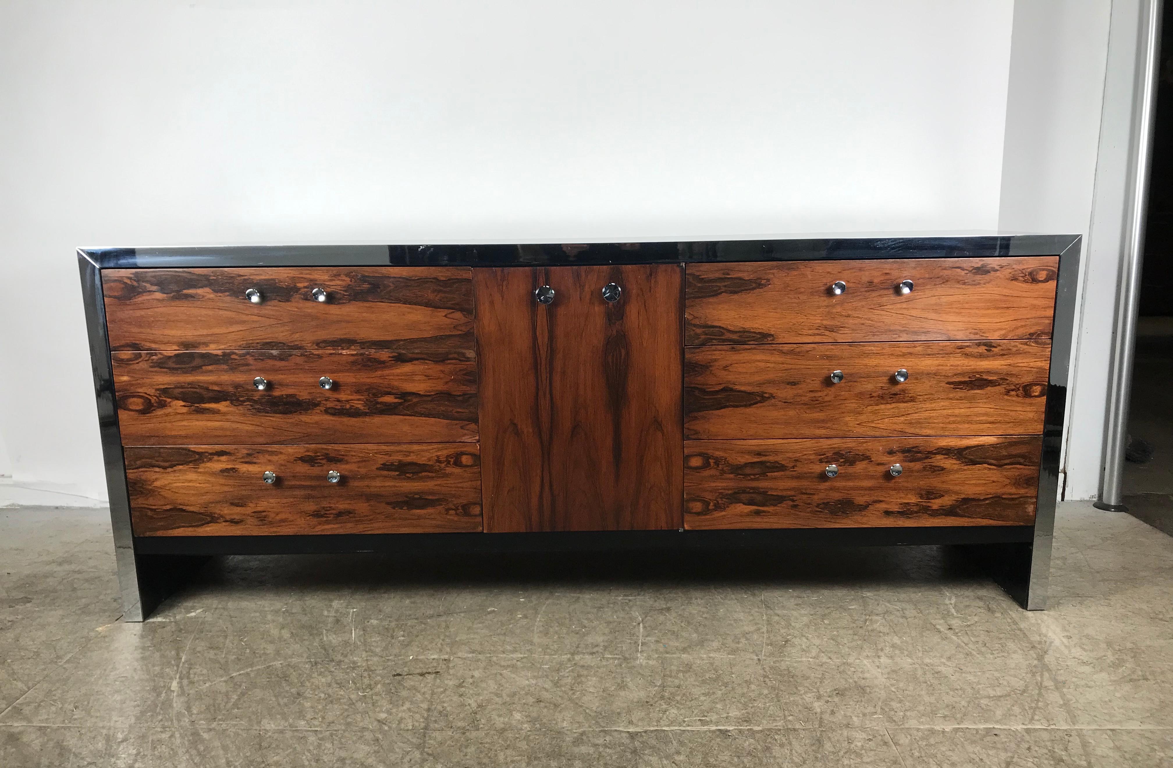 Stunning modernist rosewood dresser by Milo Baughman for John Stewart, amazing figured rosewood and black lacquer with chrome trim front, nine generous size dovetail jointed drawers, hand delivery avail to New York City or anywhere en route from