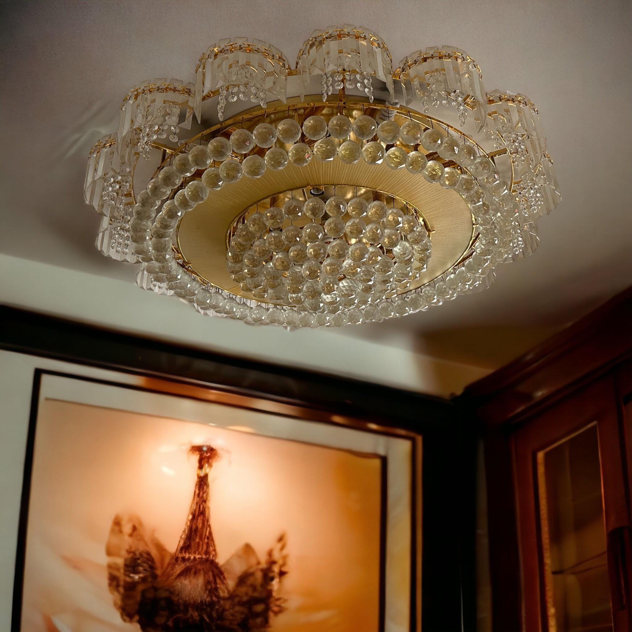 A stunning extra large chandelier flush mount with crystal glass and gold plated brass frame made by Palwa,  Germany, in the 1980s. Featuring a multitude of crystal glasses. It is possible to install this fixture in all countries (US, UK, Europe,