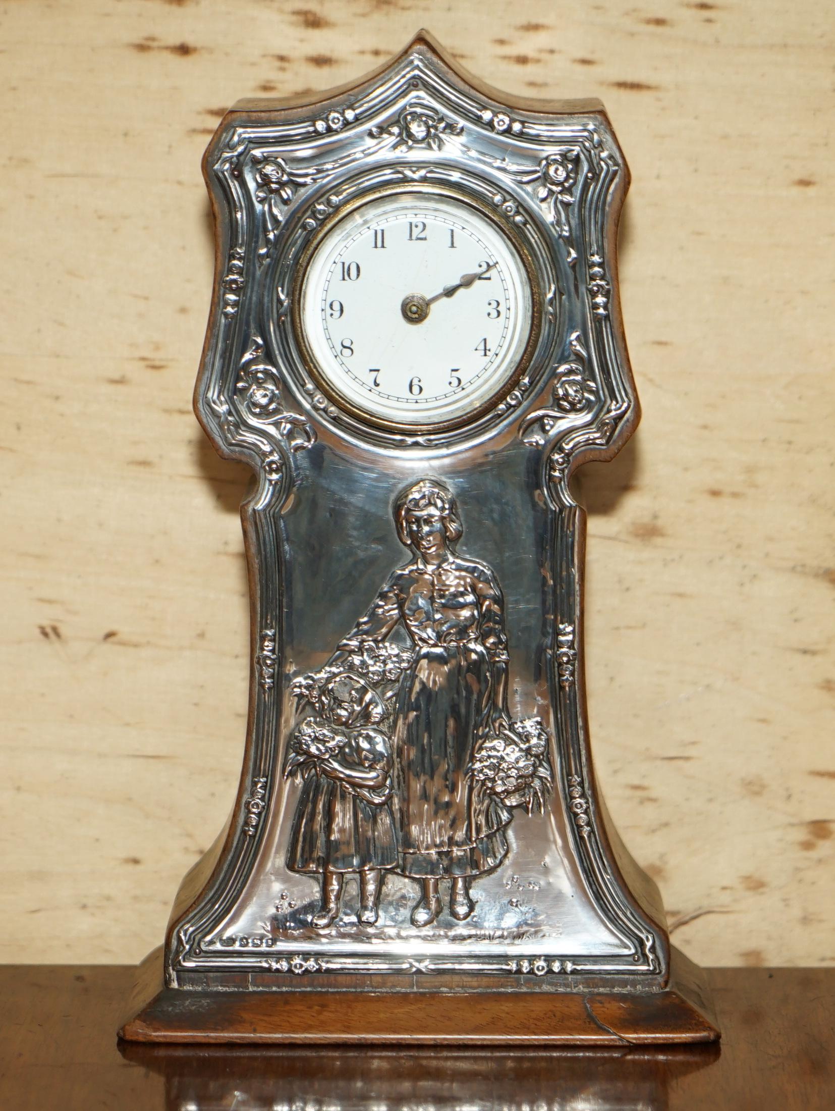 We are delighted to offer for sale this fully hallmarked 1906 Birmingham made Sterling Silver mantle clock depicting and mother and child

This clock is in totally original condition, apart from some silver polish it is untouched. It has all the