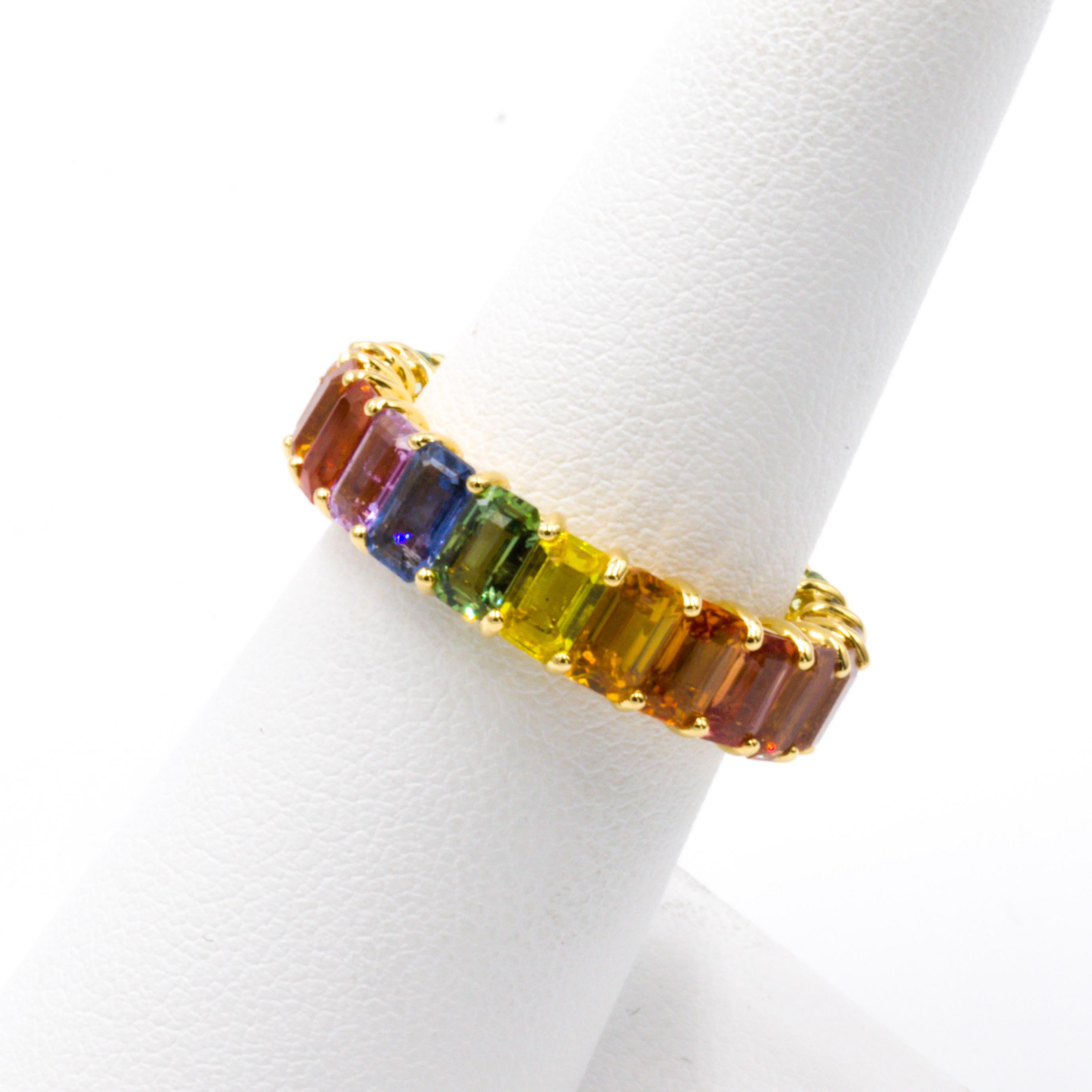 Sapphire occurs naturally in a wide variety of colors. This ring shows them all off in one place! The 23 emerald cut fancy color sapphires in this eternity band have exceptional color. This ring will look amazing regardless of which size faces