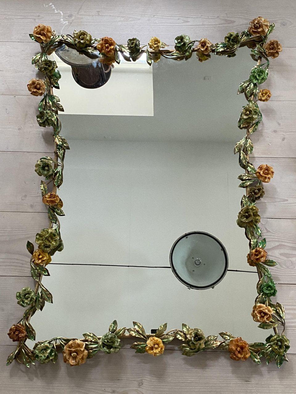 Awe inspiring and seldom found large Murano mirror, from circa 1970. Garlands of luscious flowers adorn it in colorful Venetian glass with stunning and charming mouth-blown glass flowers and green leaves along the frame.

An extremely imaginative