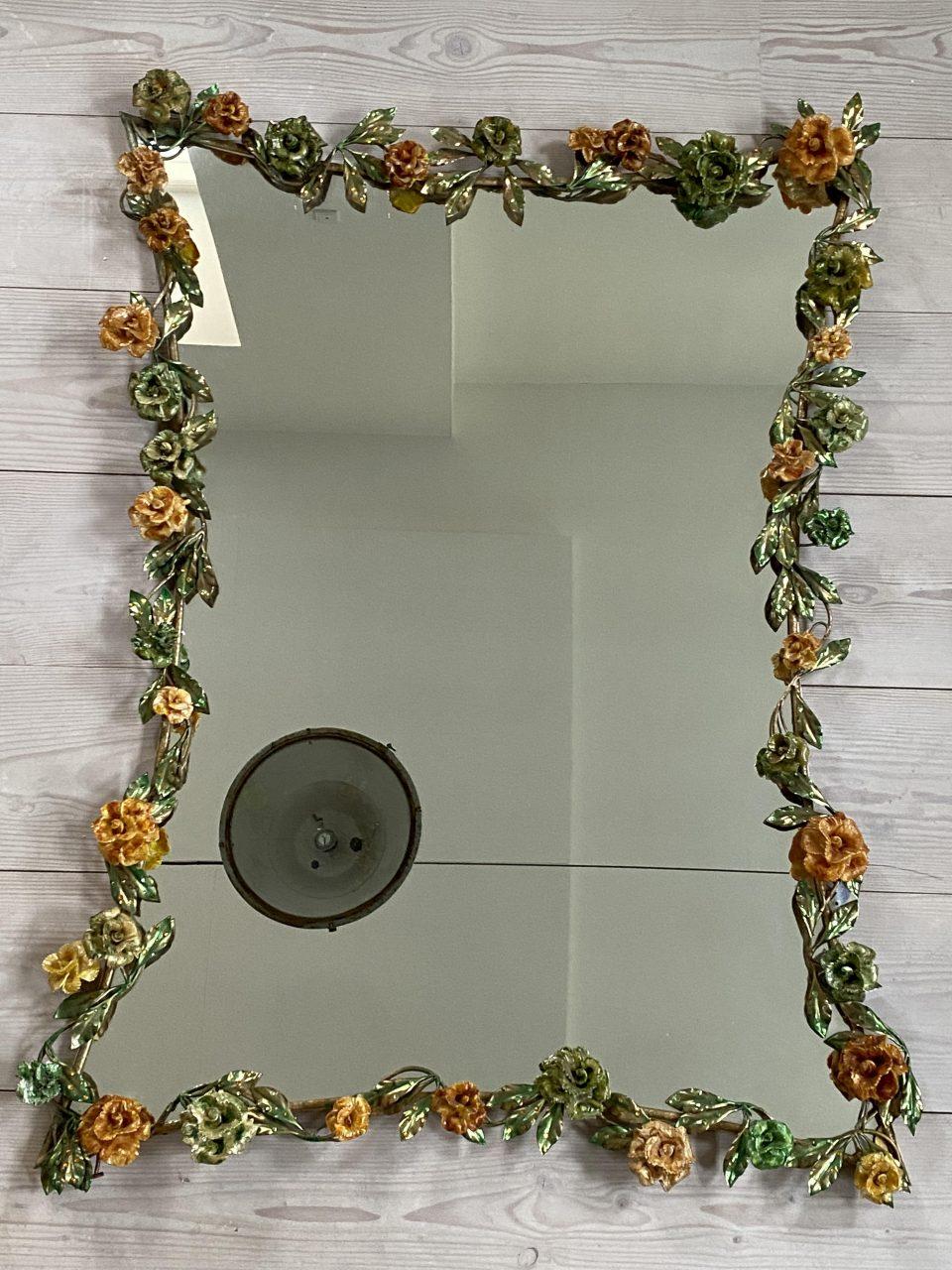 Awe inspiring and seldom found large Murano mirror, from circa 1970. Garlands of luscious flowers adorn it in colourful Venetian glass with stunning and charming mouth-blown glass flowers and green leaves along the frame.

An extremely imaginative