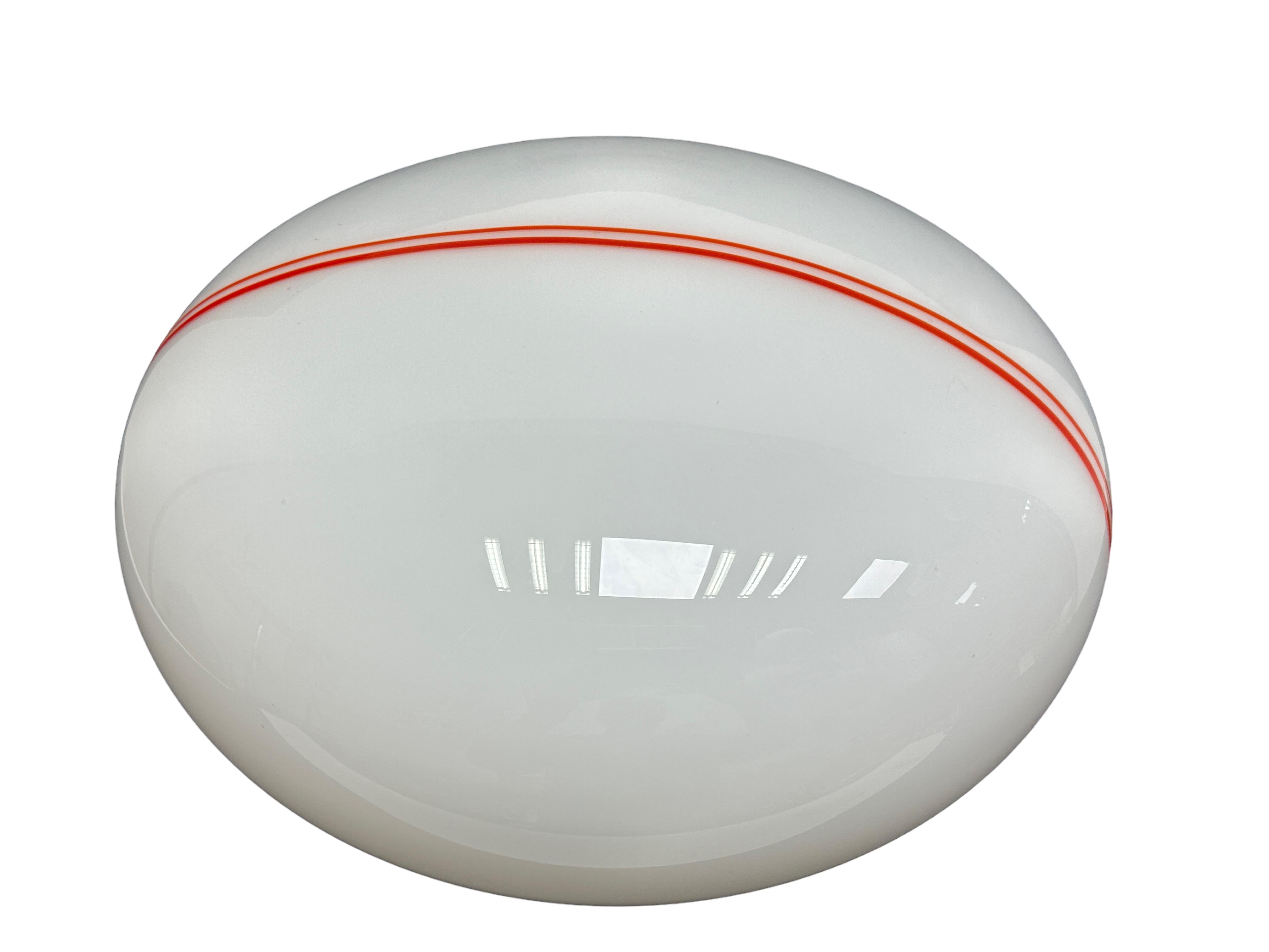 A beautiful flush mount, marked made in Italy. Made in the 1980s. The fixture requires one European E27 Edison bulb, up to 60 watts. The glass is a milk glass with a nice orange pinstripe motif. Great for any room or for your vanity or dressing room.