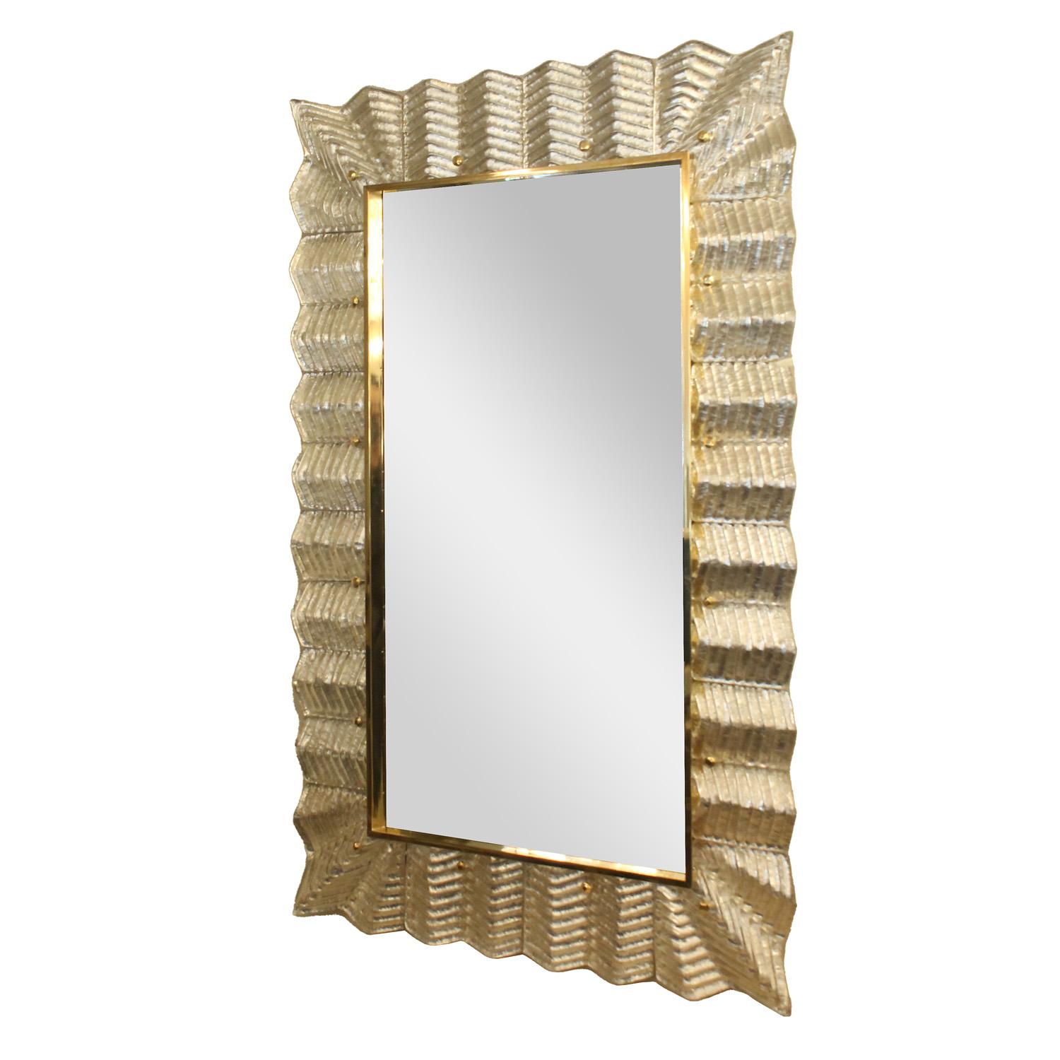 
Stunning Murano clear ribbed glass and silver leaf framed mirror with polished brass details. Italy.

 
This mirror is currentky available as shown in our NYC showroom.
Customization of dimensions and glass color are available by order.  Lead time