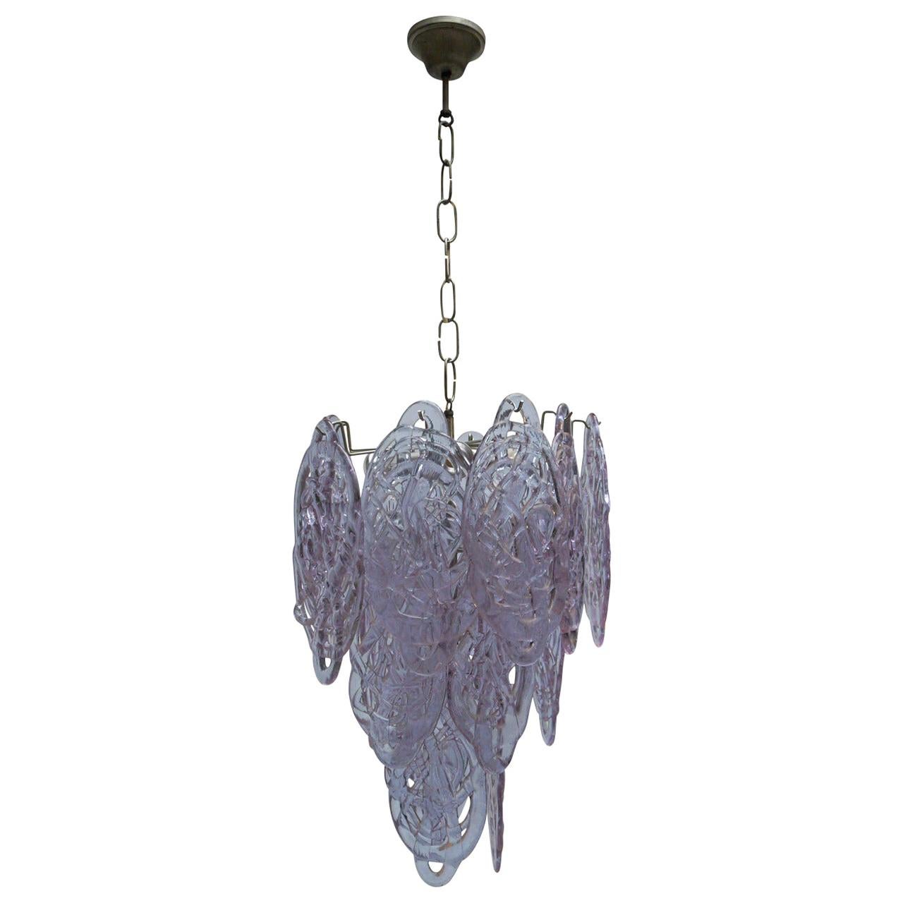 Wonderful vintage chandelier by Mazzega with purple glass pieces in a cascading motif.
The glass is made to look like spun sugar and gives a great effect when lit.
Diameter: 40 cm.
Height fixture 62 cm.
Total height including the chain 115 cm.