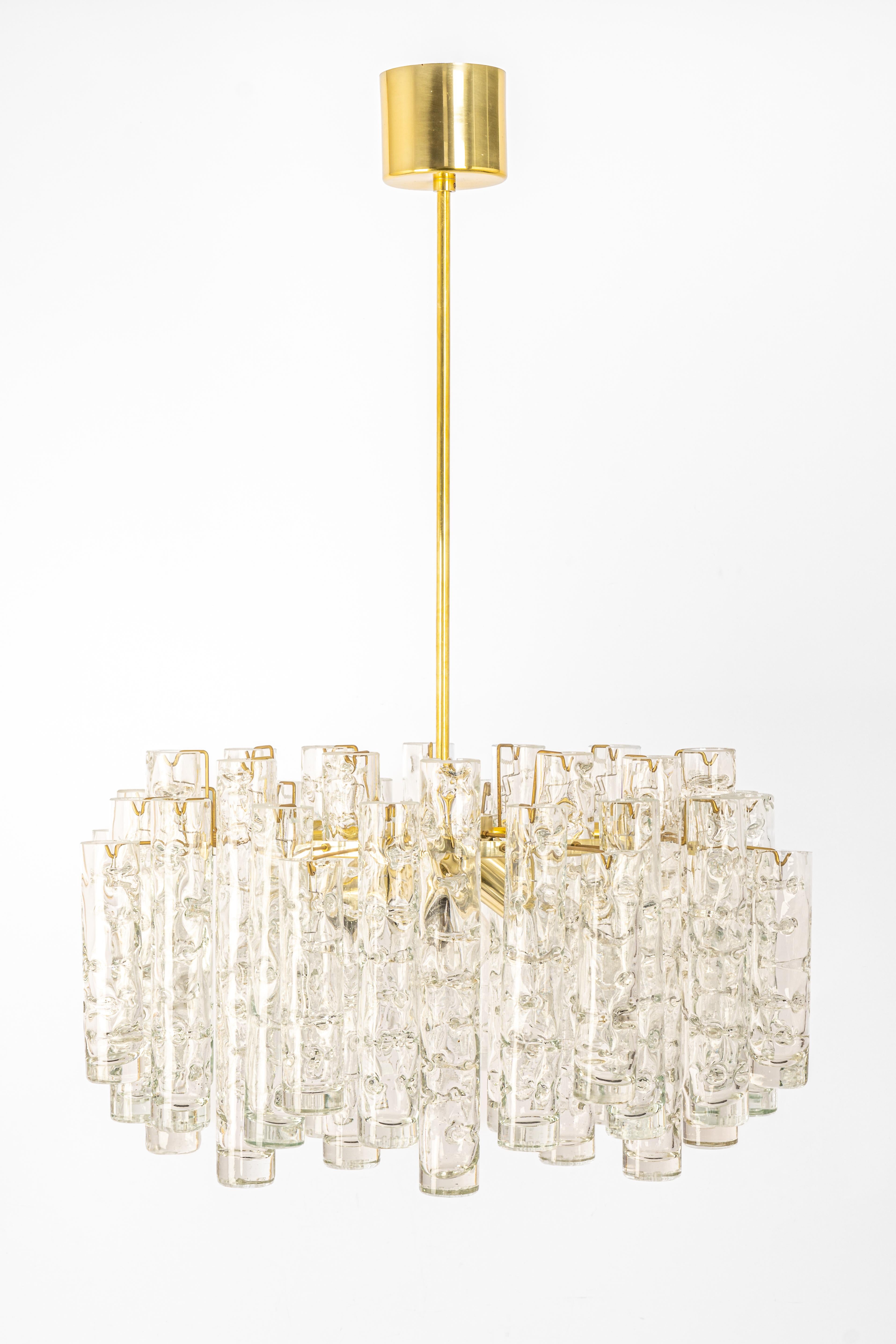 Fantastic mid-century chandelier by Doria, Germany, manufactured circa 1960-1969. A lot of Murano glass cylinders suspended from the fixture.

Heavy quality and in very good condition. Cleaned, well-wired, and ready to use.

The fixture requires 4 x