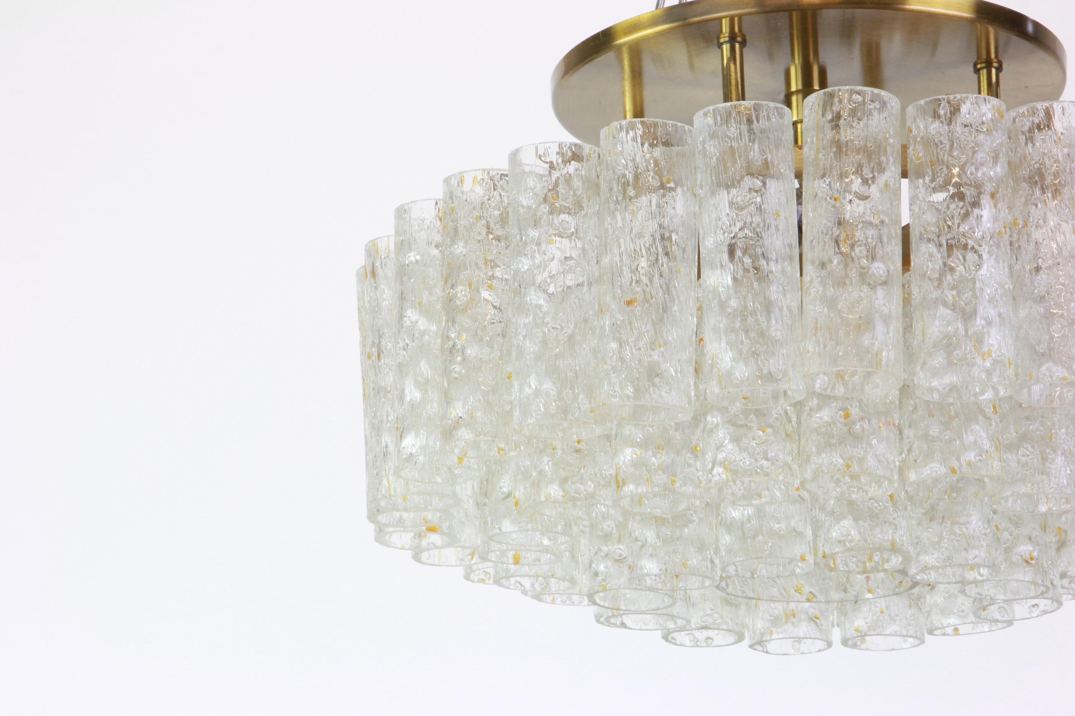 Fantastic three-tier midcentury chandelier by Doria, Germany, manufactured circa 1960-1969. 60 Murano glass cylinders suspended from the fixture.

Heavy quality and in very good condition. Cleaned, well-wired and ready to use. 

The fixture requires