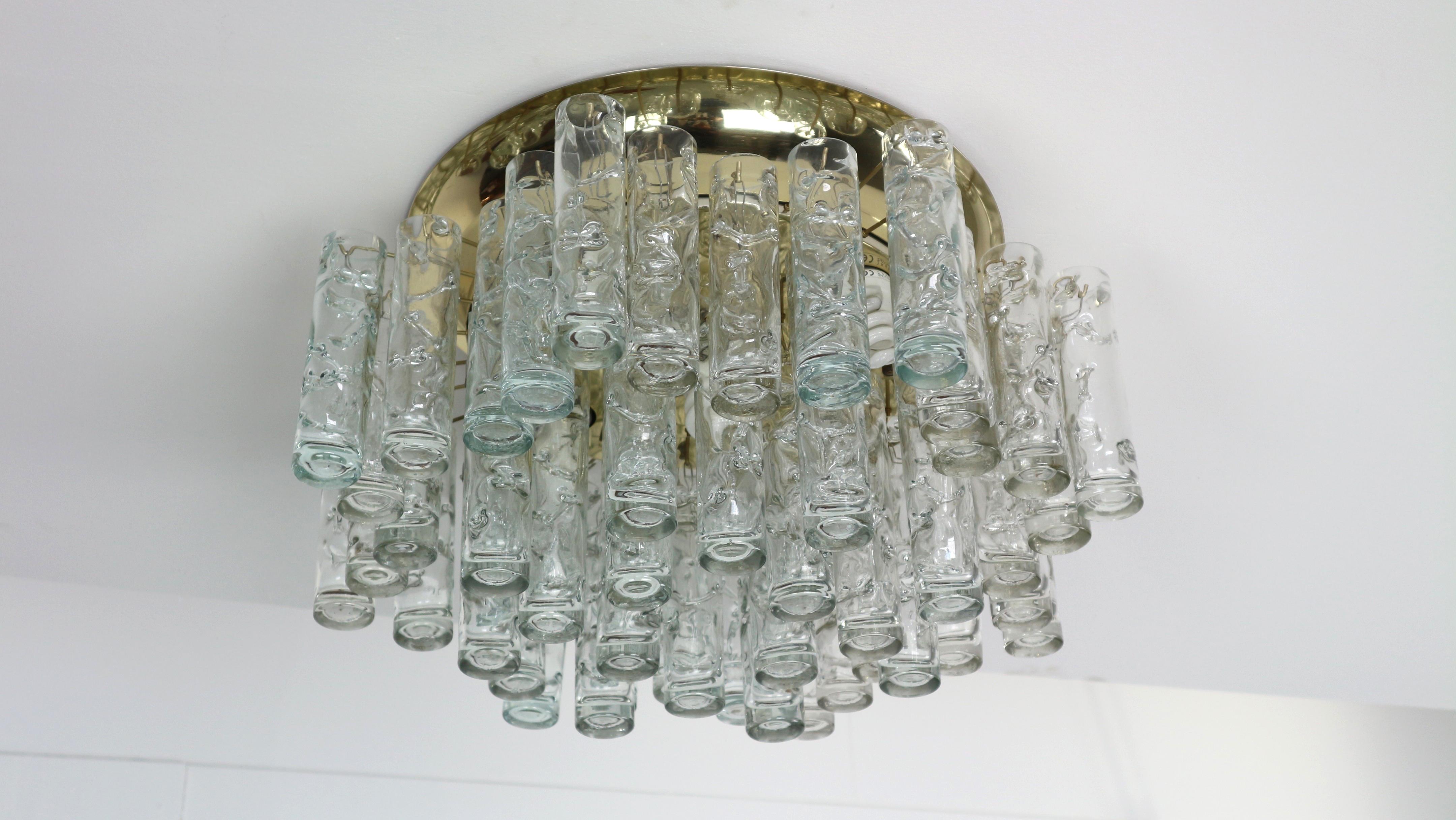 Fantastic midcentury chandelier by Doria, Germany, manufactured circa 1960-1969. 48 Murano glass cylinders suspended from the fixture.

Heavy quality and in very good condition. Cleaned, well-wired and ready to use.

 The fixture requires 5 x