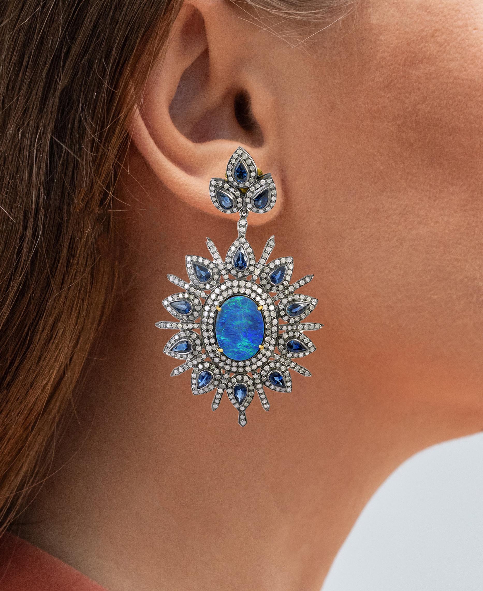 It comes with the appraisal by GIA GG/AJP
Black Opals = 6.70 Carats
Diamonds = 5.20 Carats
Blue Sapphires = 7 Carats
Dimensions: 65 x 39 mm
Metal: 18K Yellow Gold, Sterling Silver