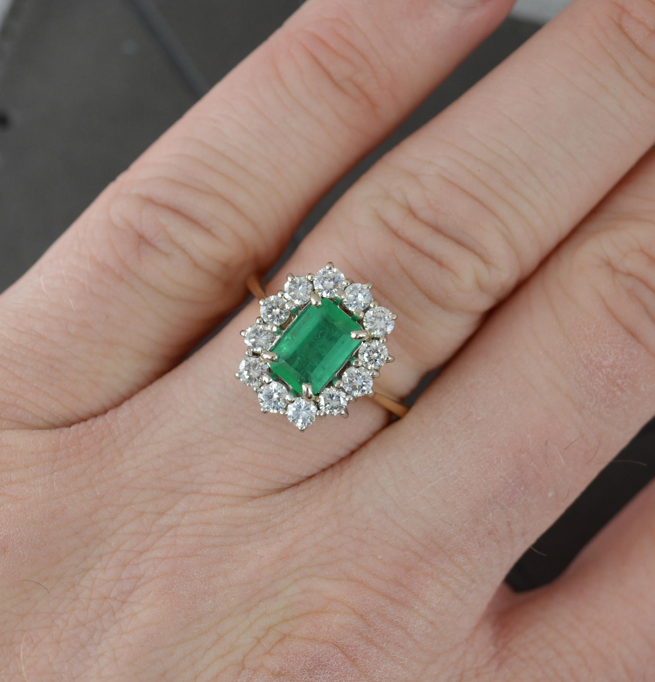 A superb emerald and diamond ring.
Solid 18 carat yellow gold shank with white gold head setting.
Designed with an emerald cut emerald to the centre, 5.25mm x 7.8mm. Surrounding is a full border of twelve round brilliant cut diamonds to total approx