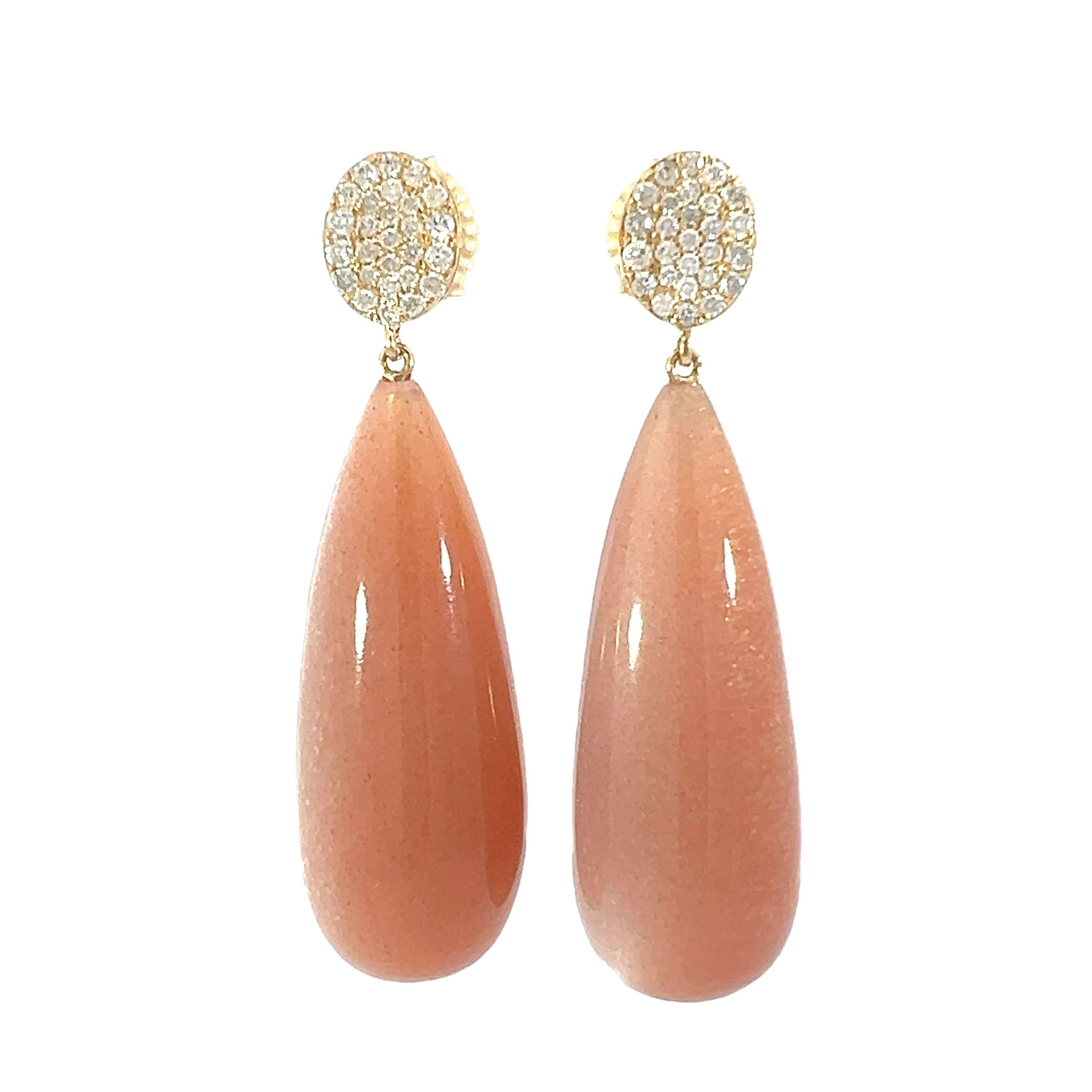 A magnificent pair of naturally occurring peach moonstones 101.70 carats, set in 18-karat yellow gold with 0.60 carats of diamonds. These gorgeous teardrop earrings are the ideal piece to add a touch of sophistication to any combination. Perfect for