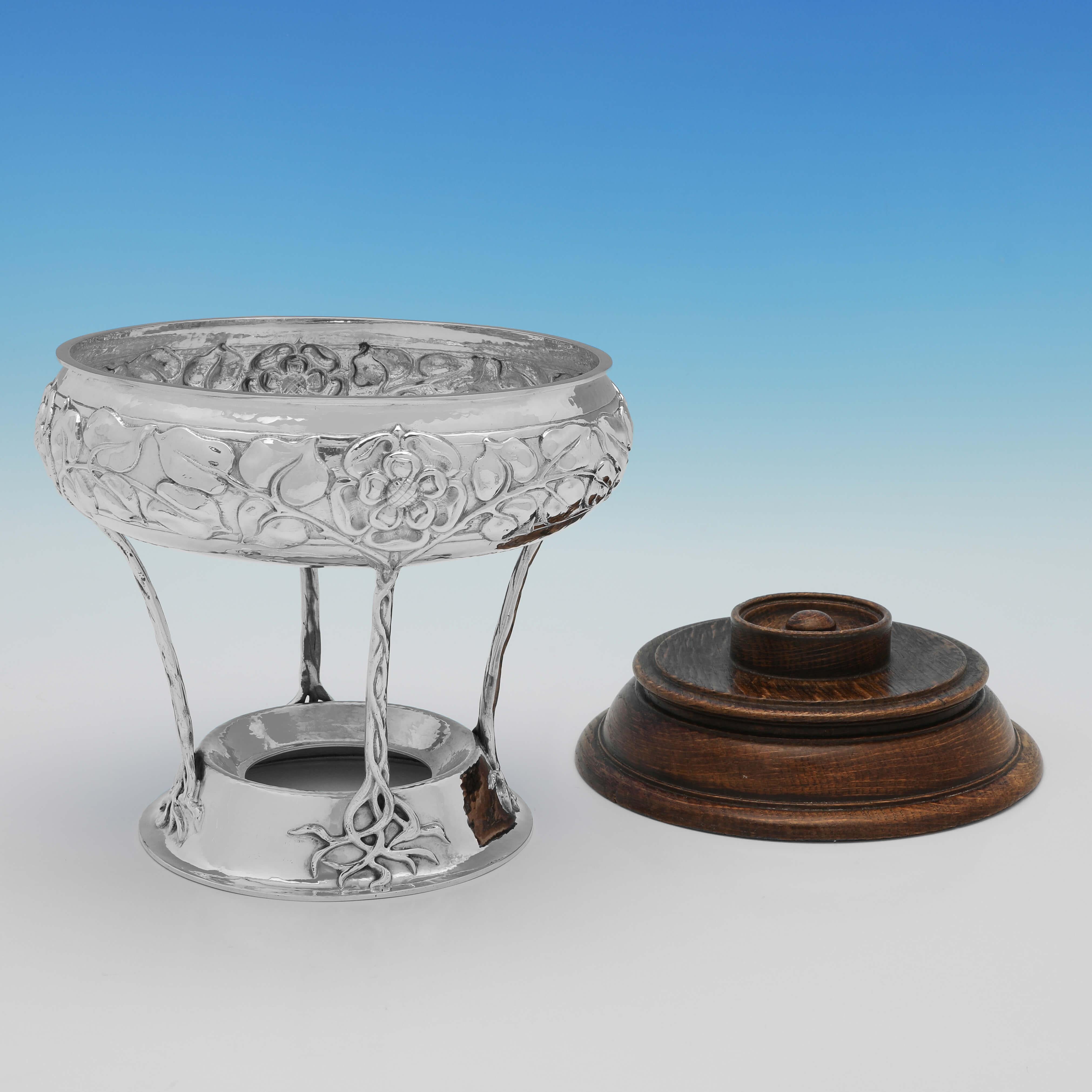 Hallmarked in Birmingham in 1924 by Connell, this wonderful Sterling Silver Bowl on Stand, is in the Arts & Crafts taste with naturalistic decoration throughout, and standing on a wooden base. The bowl on stand measures 9.75