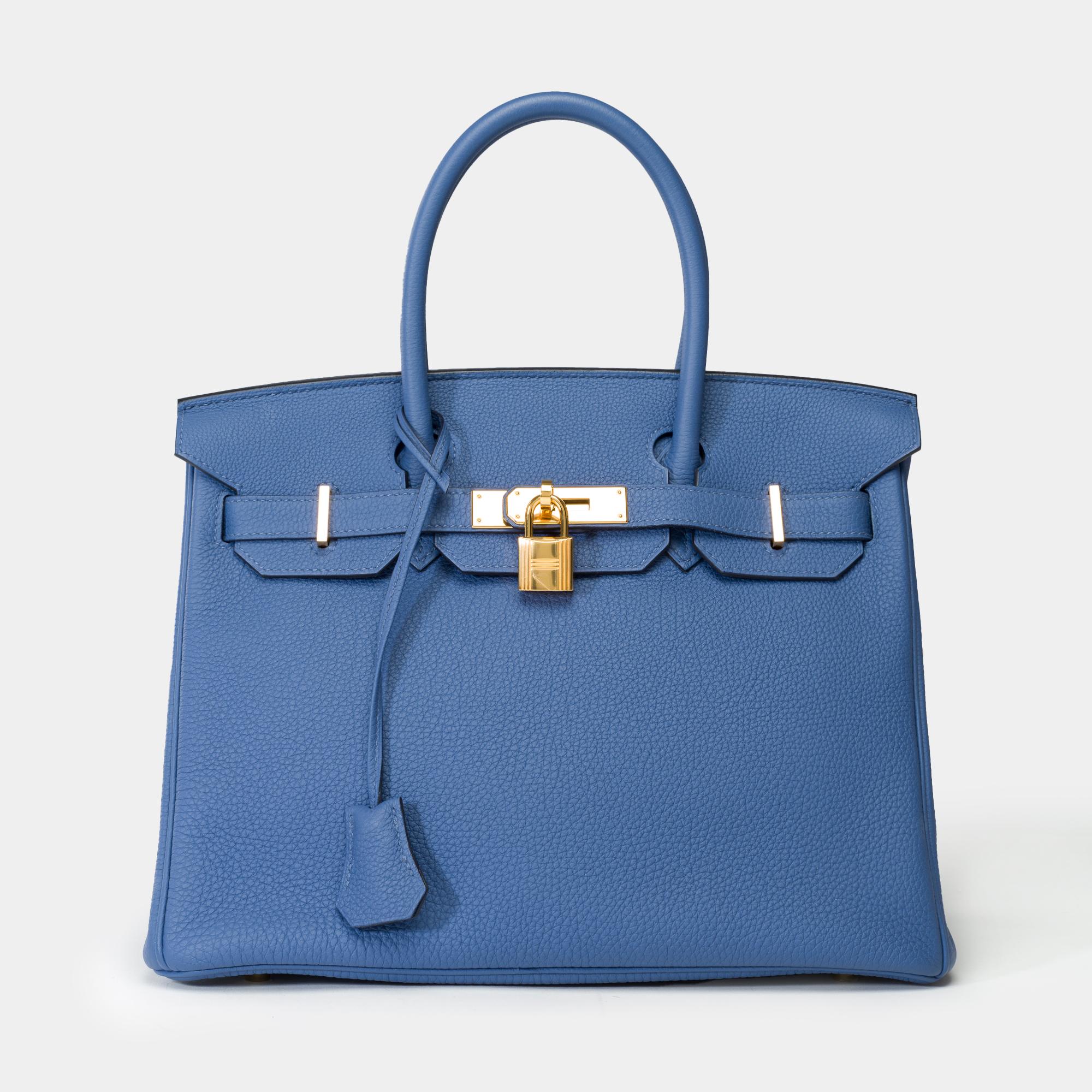 Exceptional​ ​and​ ​highly​ ​sought-after​ ​Hermes​ ​Birkin​ ​30​ ​handbag​ ​in​ ​Bleu​ ​Brighton​ ​Togo​ ​leather,​ ​gold-plated​ ​metal​ ​hardware​ ​and​ ​double​ ​handles​ ​in​ ​blue​ ​leather​ ​for​ ​hand​ ​carry

Features​ ​a​ ​flap​ ​closure​