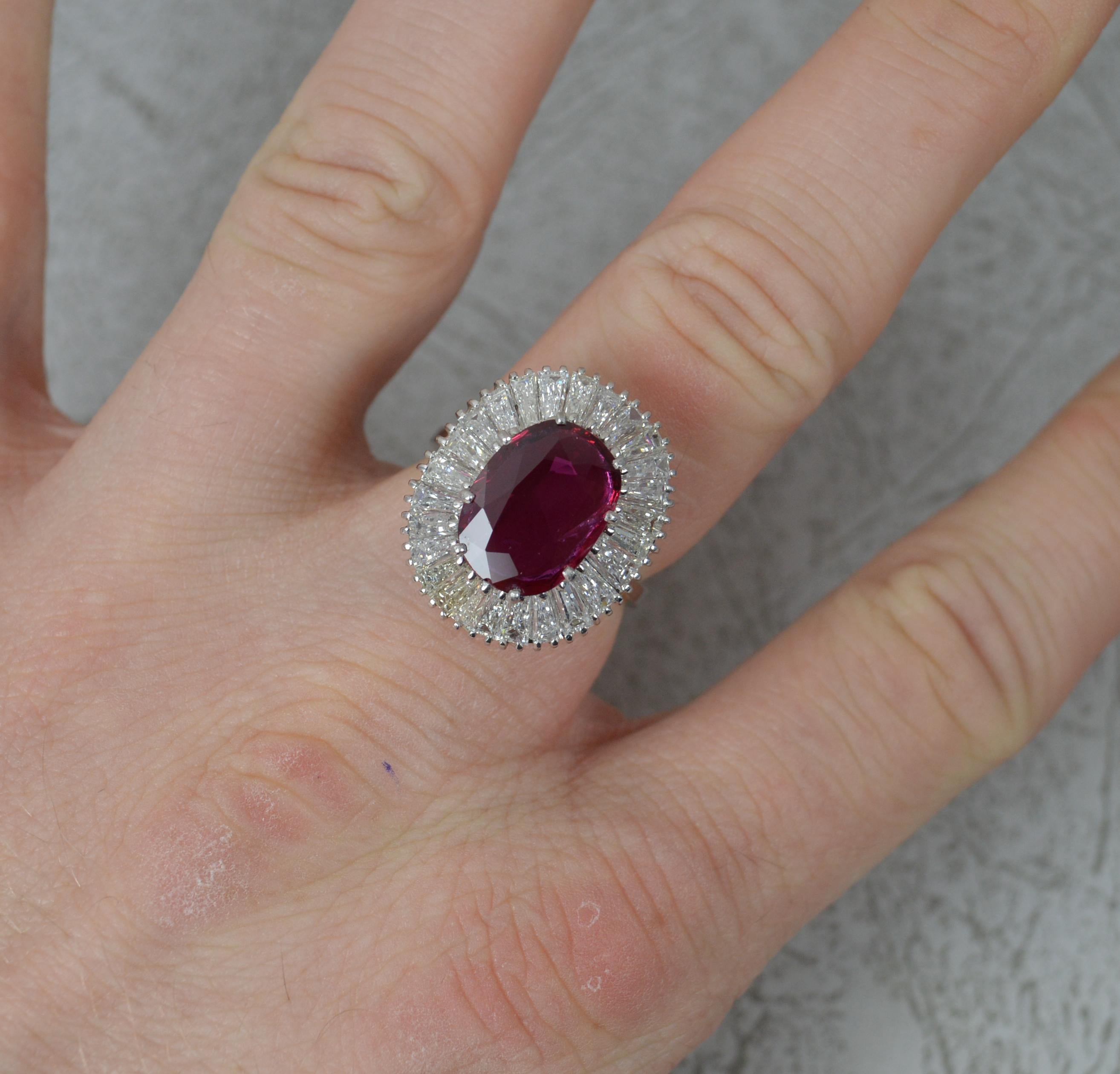 A stunning quality cluster cocktail ring of ballerina design.

Solid 18 carat white gold example.

Set with a natural, untreated, ruby in multi claw setting. 9mm x 12.3mm. Beautiful colour and transparent. Surrounding are over 25 tapered baguette