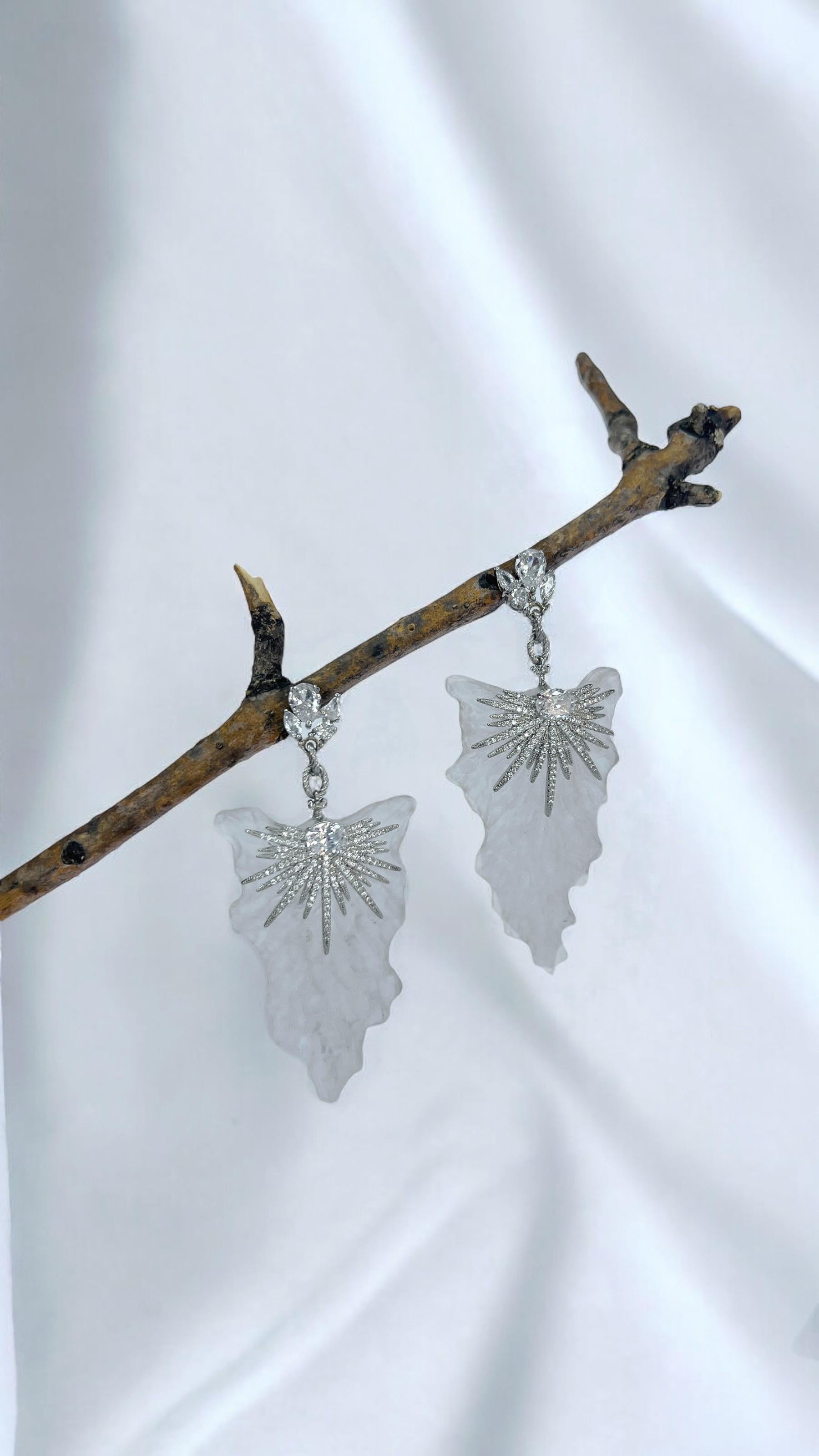 Bold, elegant, and unlike anything else—these one-of-a-kind earrings redefine luxury. Set on white gold-plated metal, they dazzle with Swarovski crystals that catch the light with every movement. The true statement, however, comes from the
