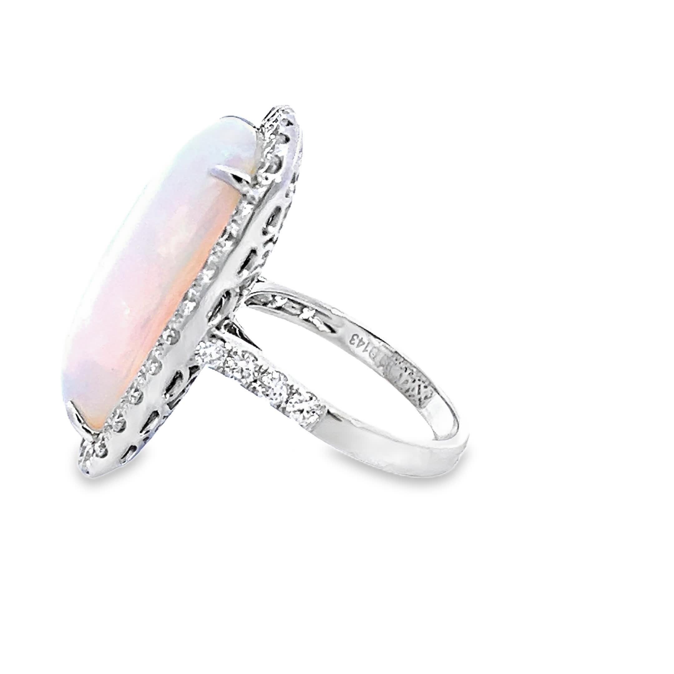 This exquisite ring features a mesmerizing opal at its center, surrounded by a sparkling halo of diamonds. The opal's iridescent colors shift beautifully in the light, making it a captivating piece for any jewelry collection. Perfect for special