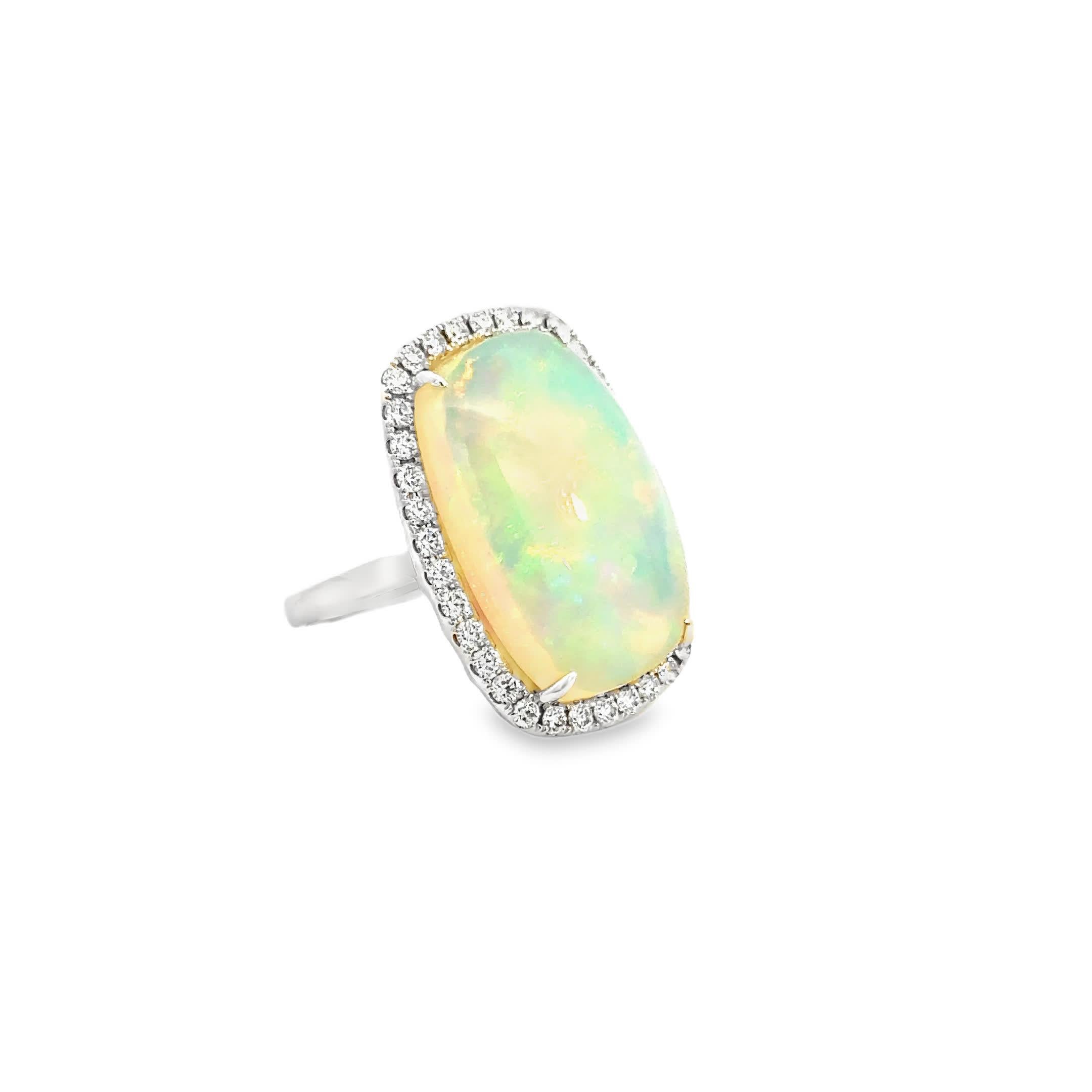 This 14k Ring features a mesmerizing Opal at its center, surrounded by a sparkling halo of diamonds. The opal's iridescent colors shift beautifully in the light, making it a captivating piece for any jewelry collection. Perfect for special occasions