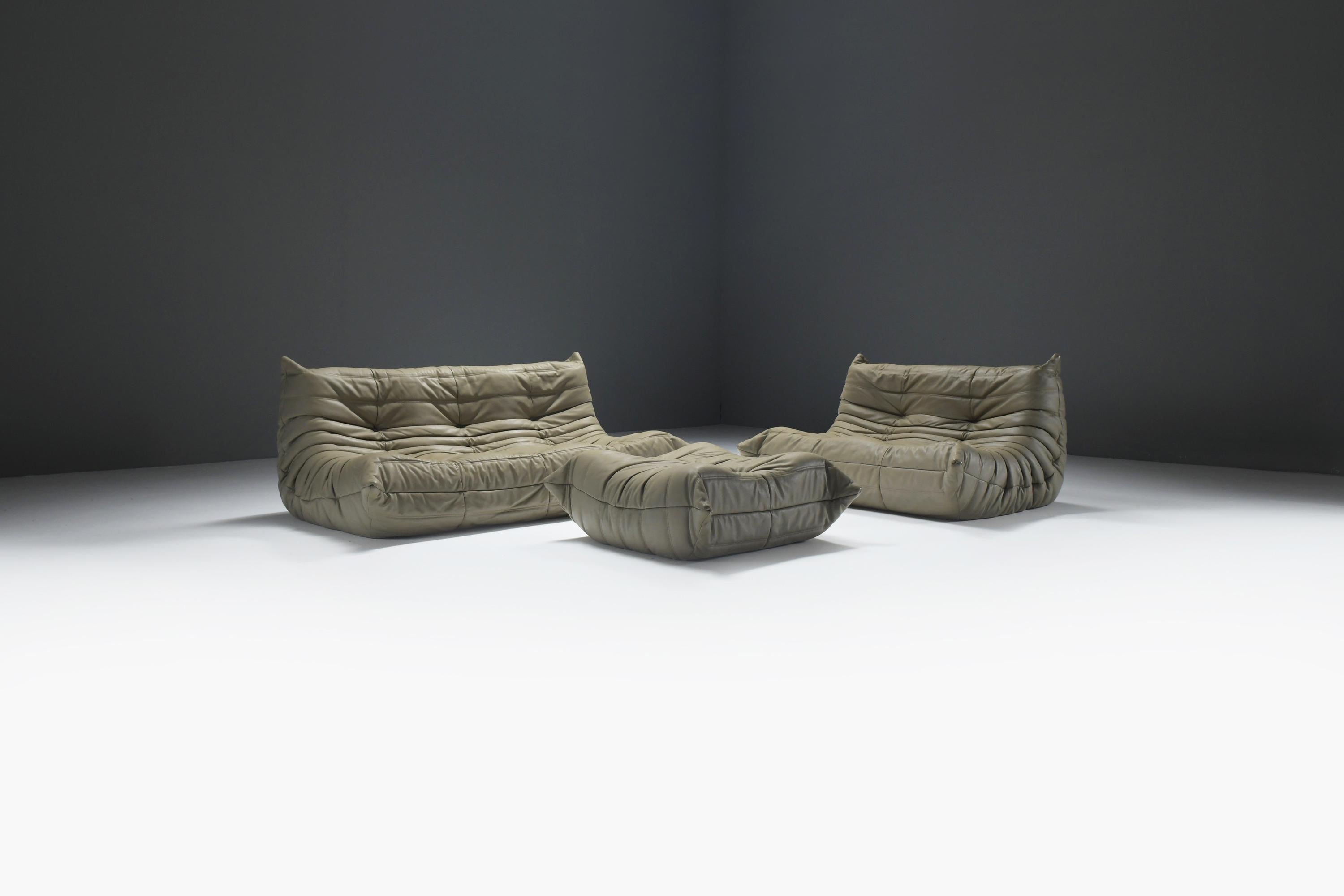 Stunning Togo seating set, crafted in a beautiful khaki leather, exudes a classic, stylish elegance. The 13-year-old leather has developed a lovely natural patina over time.
Designed by Michel Ducaroy for Ligne Roset.

The timeless Togo collection