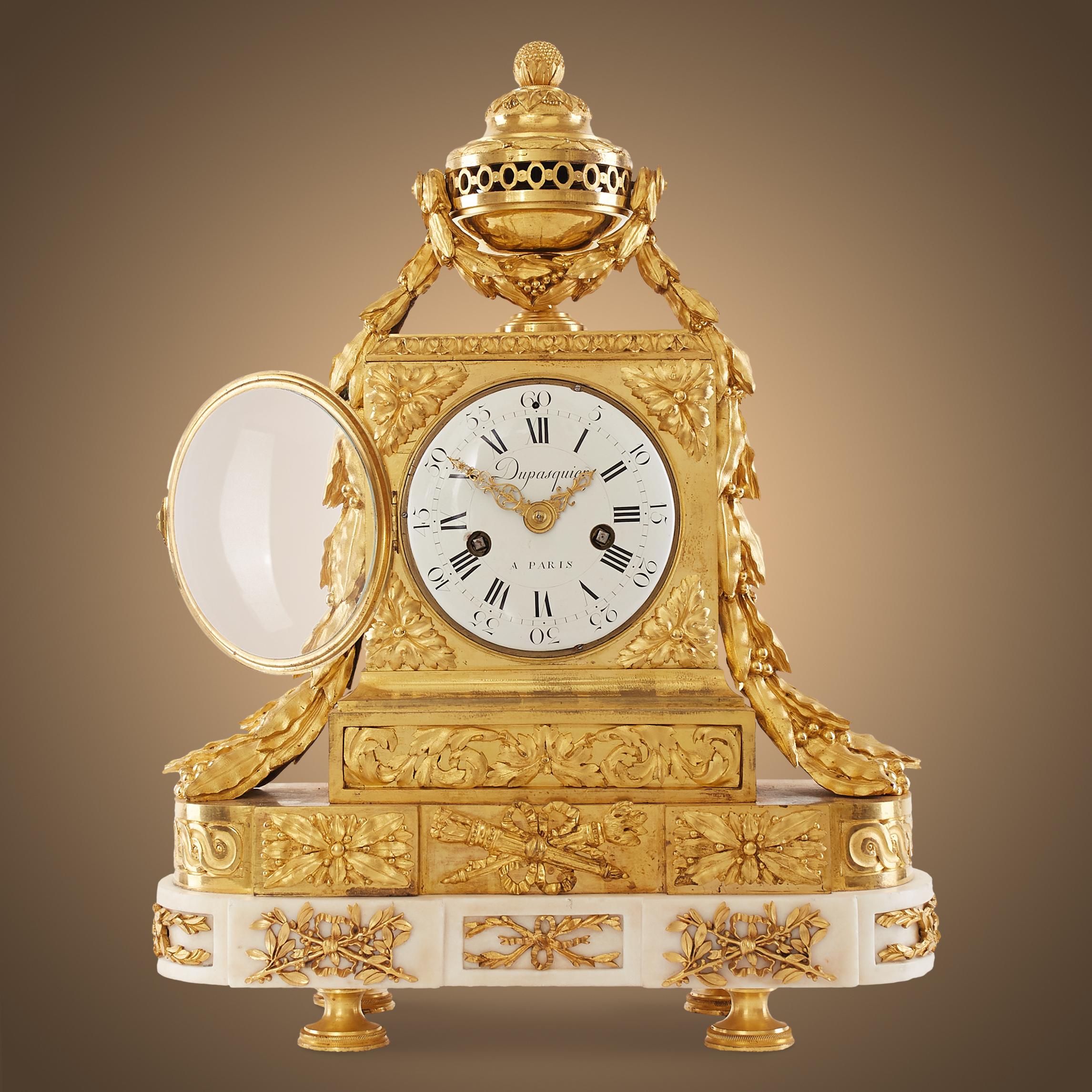 The outstanding mantel clock is in the style of Louis XVI – Louis Seize (1774-1792). Royal breath appears in each motif. 
Almost the entire upper part of the clock is inlaid with ormolu but only the pedestal is made of extremely delicate