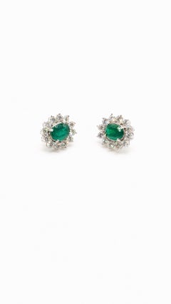 Stunning Oval Cut Emerald Earrings Surrounded by Brilliant Diamonds