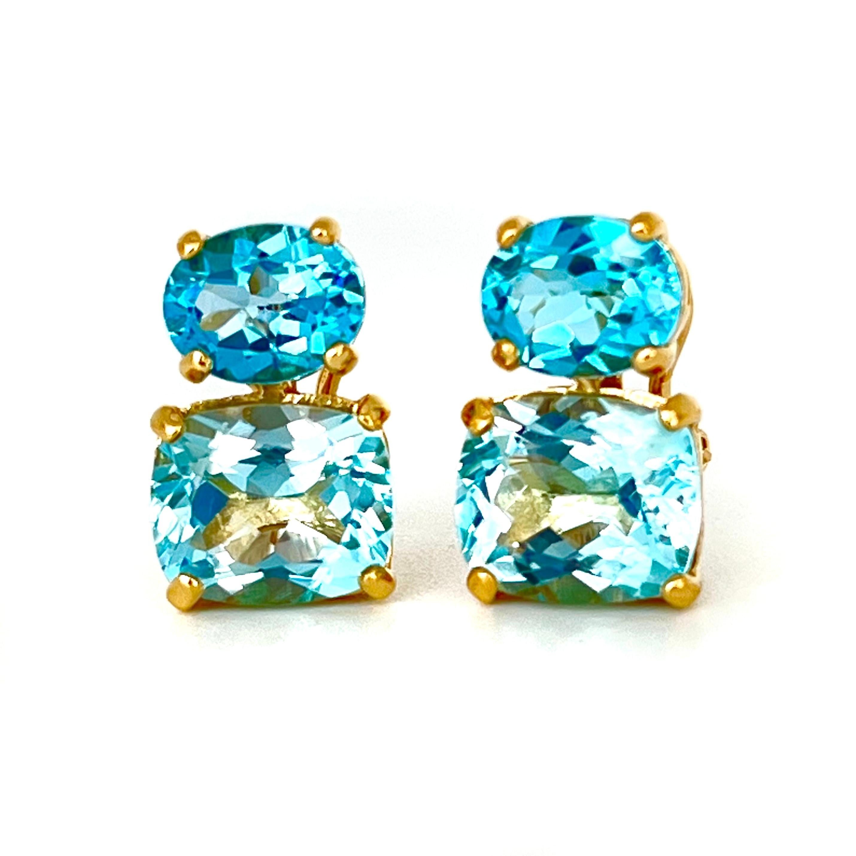 These stunning pair of earrings features a pair of genuine oval Swiss blue topaz with cushion-cut sky blue topaz, handset in 18k yellow gold vermeil over sterling silver. The double blue combination creates stunning two-tone blue hue! They are just