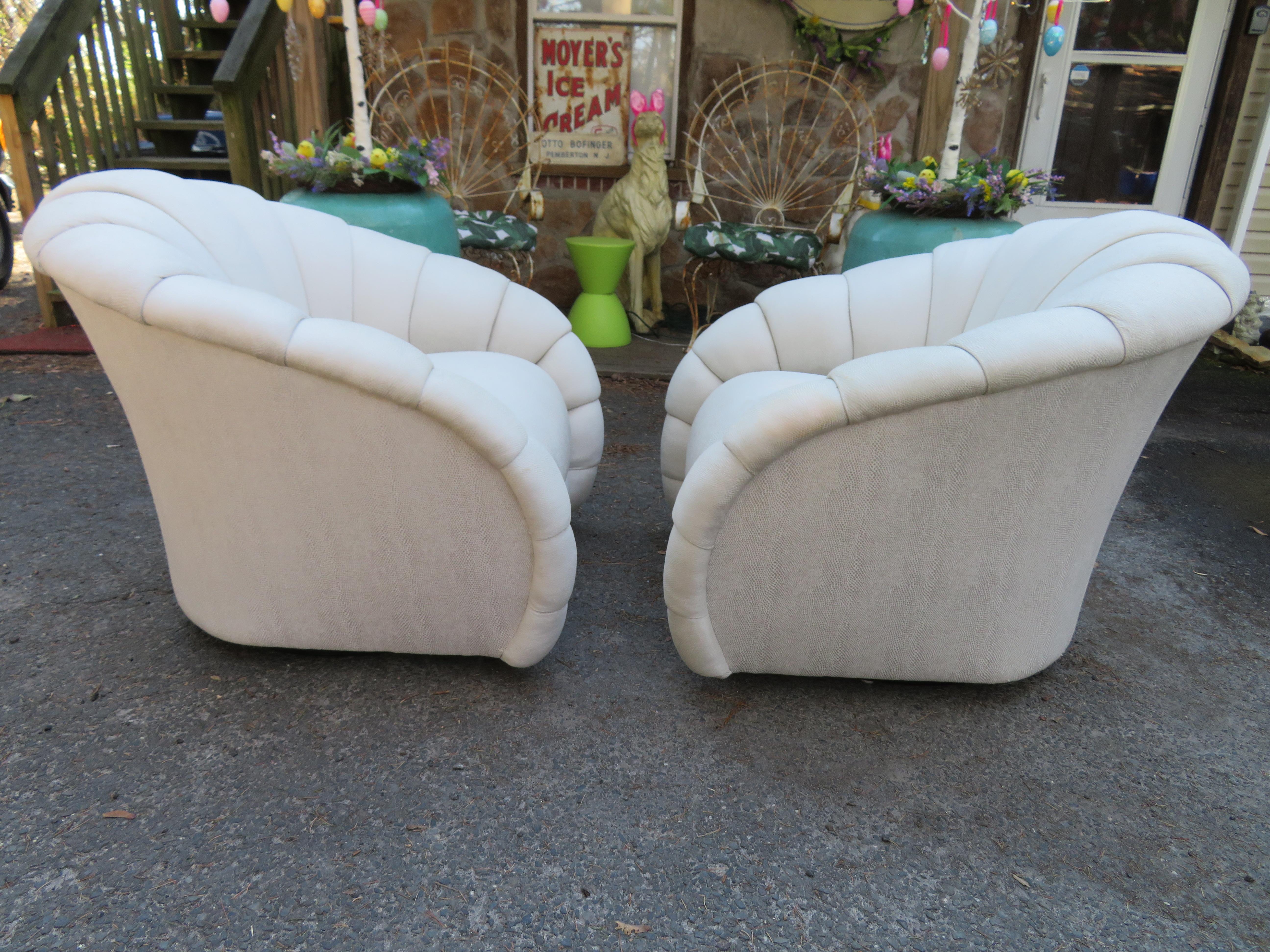 Stunning pair of Directional crescent roll tufted swivel lounge chairs. These wonderful chairs are oversized and very comfortable. The original fabric is not bad and could be cleaned to use as is but we do recommend reupholstery. These chairs