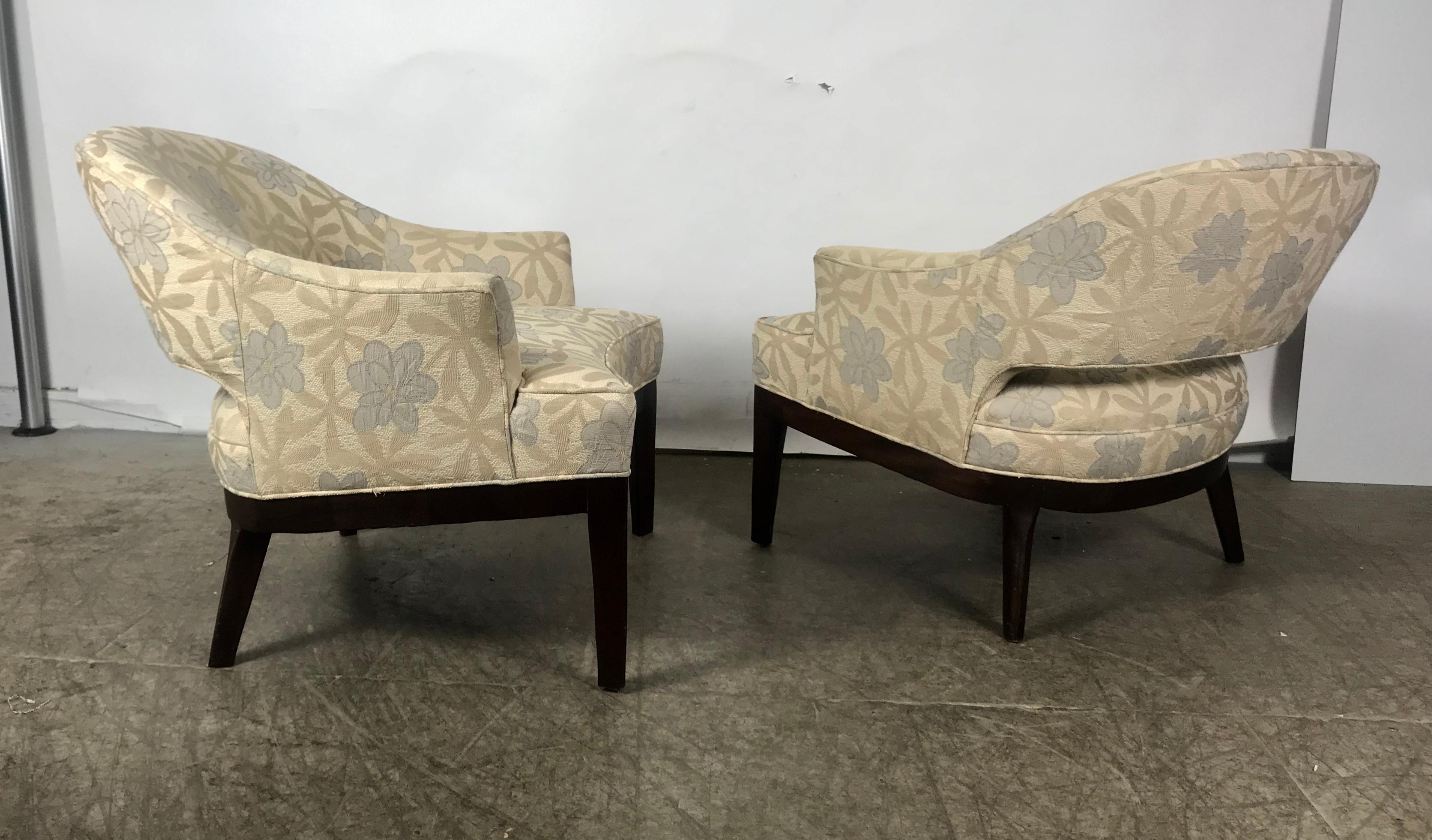Stunning pair of modernist lounge chairs. Retain original stylized floral fabric. Wonderful condition. Heavy, sturdy solid mahogany frames. Extremely comfortable. Hand delivery avail to New York City or anywhere en route from Buffalo NY.