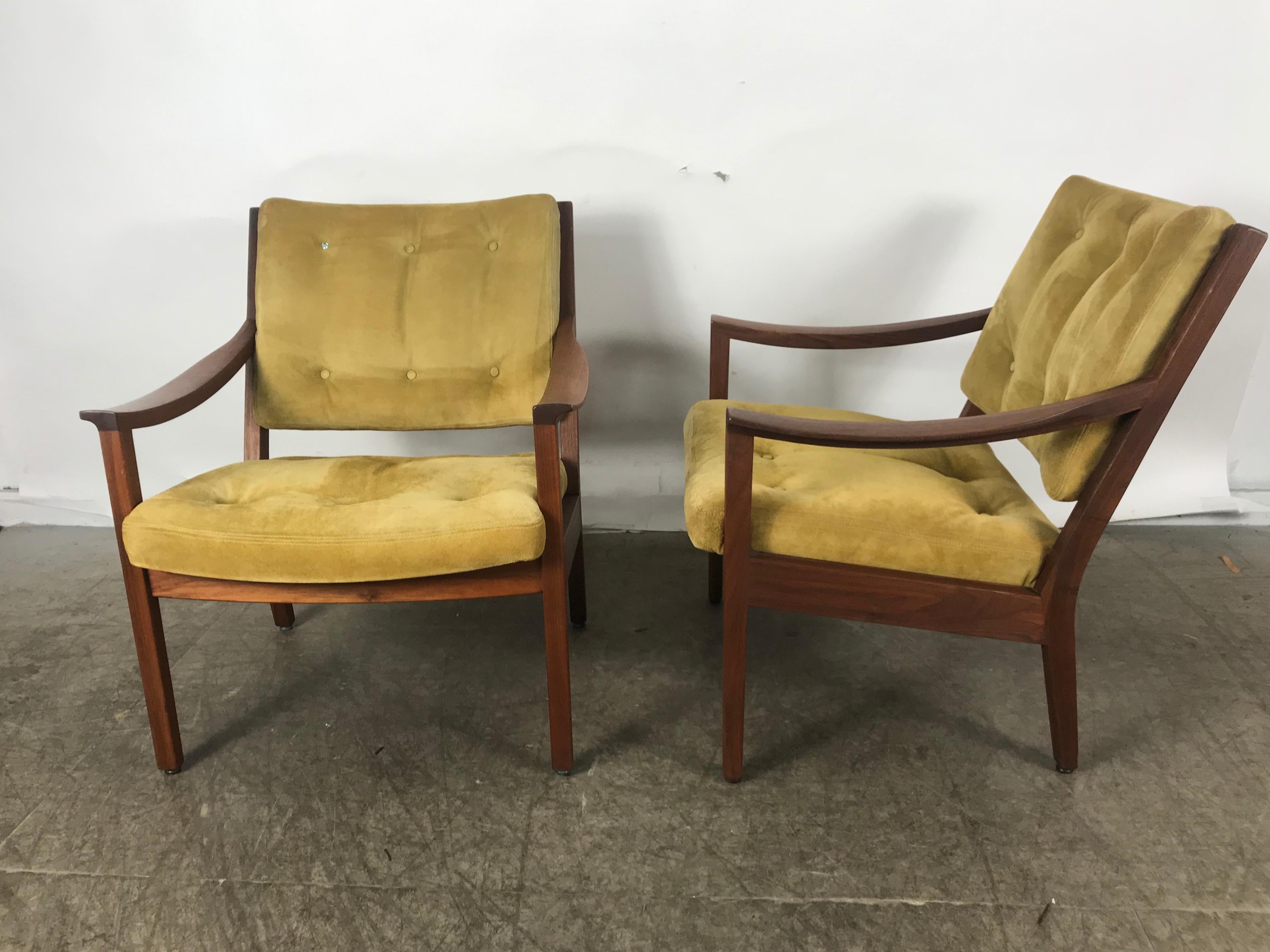 Stunning pair of modernist walnut and suede lounge chairs by Gunlocke. Superior quality and construction, beautiful warm solid walnut, wonderful patina, Classic midcentury styling, extremely comfortable, generous wide and deep seat, retains original