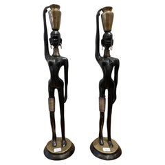 Stunning pair of African lady carrying water, in the style of  Hagenauer 1970