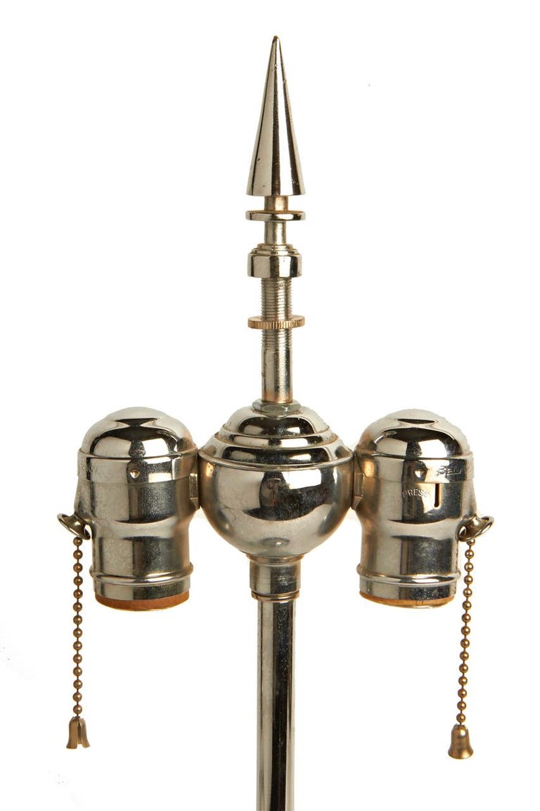 This absolutely stunning pair of twin socket, chrome and nickel plated lamp bases were created for the Pittsburgh Lamp, Brass and Glass Company. Known as Fountain Lamps they feature a pointed elongated chrome cone pointed finial on top of a chrome