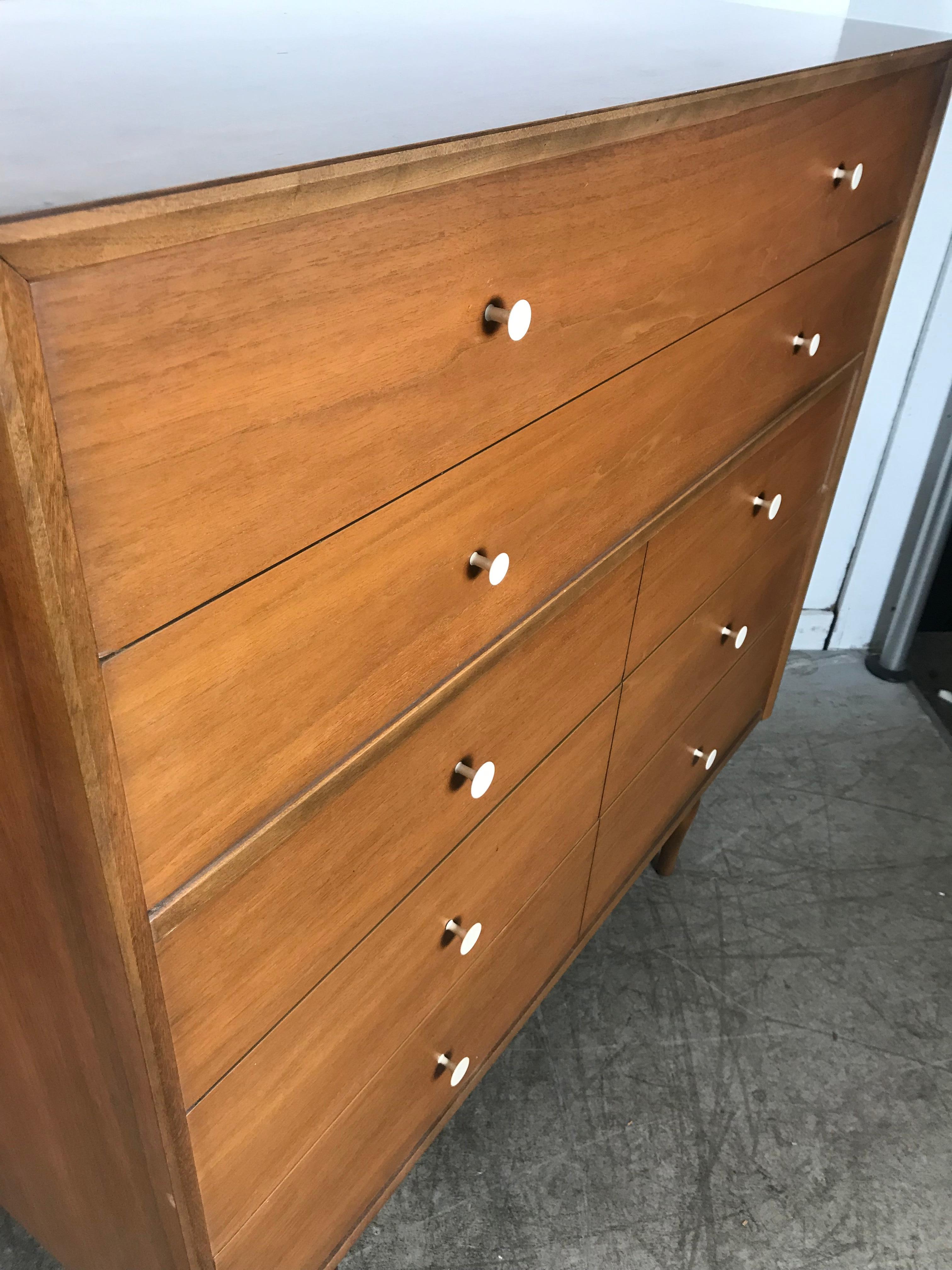 Stunning pair of American modernist 5-drawer chests. Very reminiscent of the classic designs by George Nelson, Paul McCobb etc. Handsome off white porcelain drawer pulls adorn this quality warm walnut wood, nice original finish and patina. Unusual