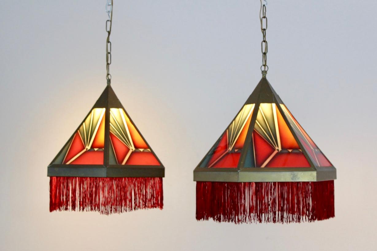 Beautiful set of ‘Amsterdamse School’ stained glass Art Deco pedant lights, manufactured in the 1920s in the Netherlands. Very subtle Dutch design pendants in hexagon shape featuring 6 glass panels and beautiful colored glasses in a brass armature,