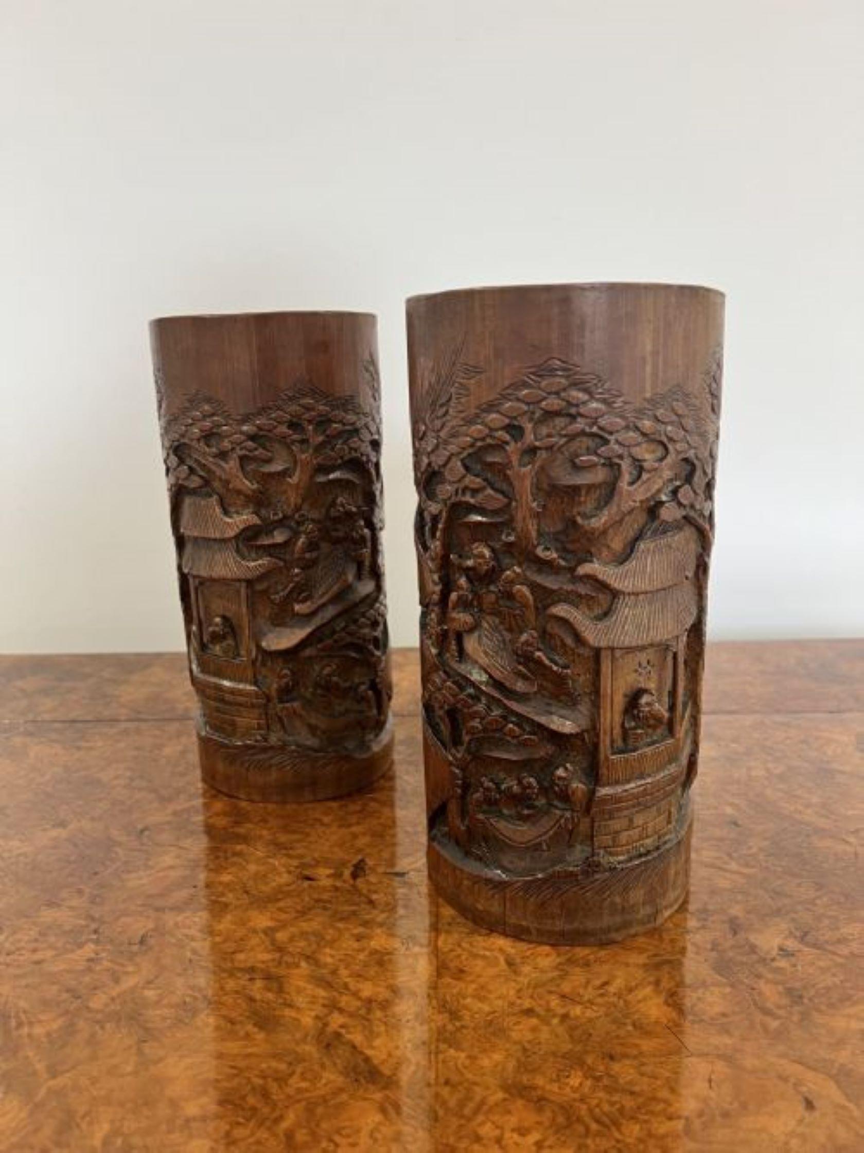 Stunning pair of antique Chinese quality carved bamboo brush pots having a quality pair of antique Chinese brush pots with quality carved decoration to the front with traditional scenes of figures, trees and a house.  