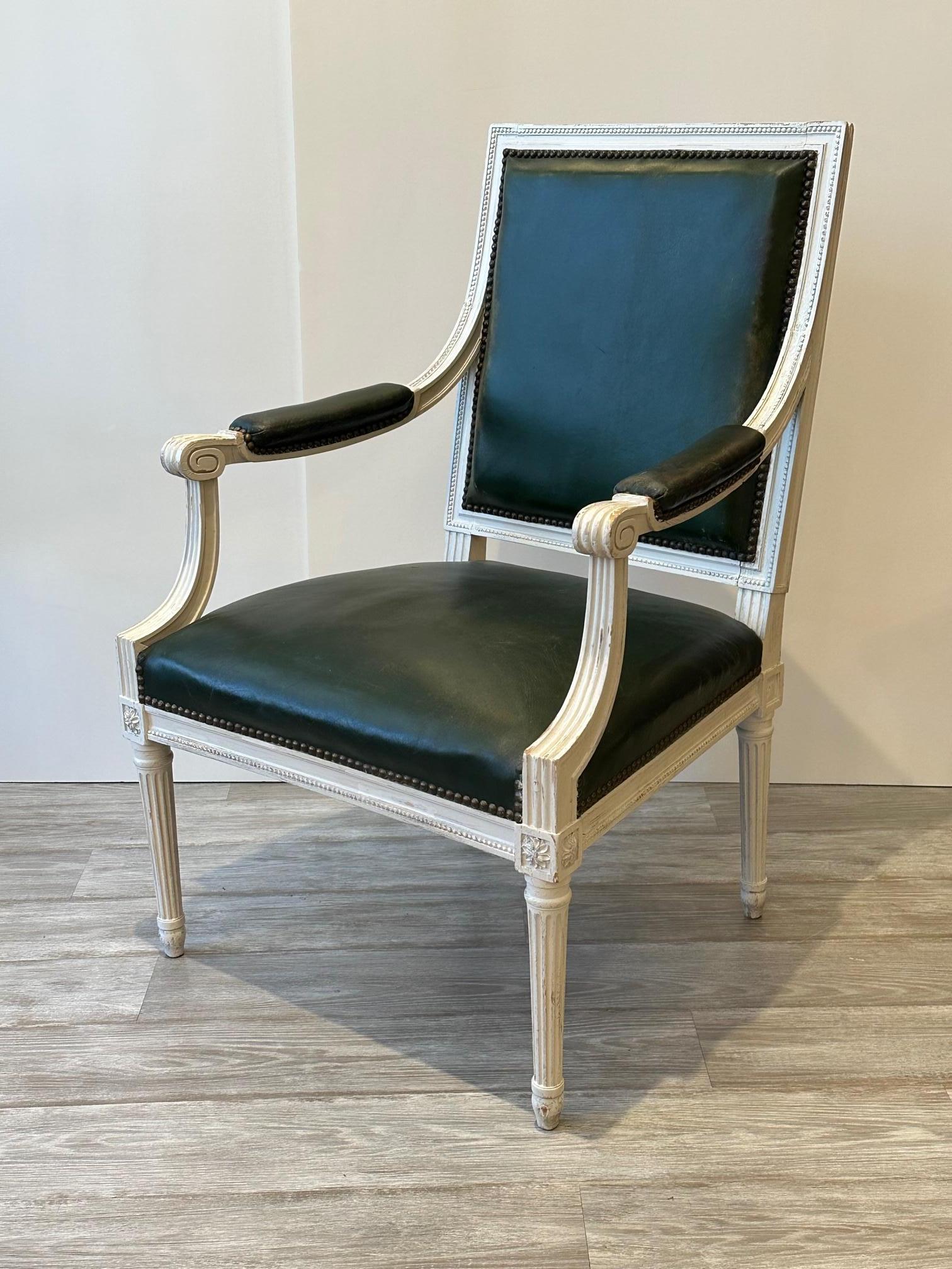 Great looking antique Louis XV style armchairs painted white with handsome dark green leather upholstery and brass nailheads.