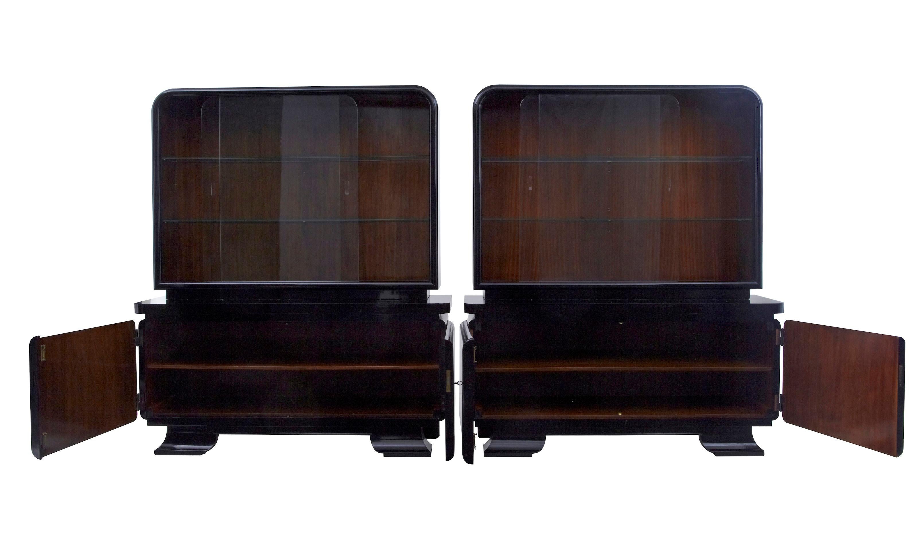 Stunning pair of art deco black lacquered sideboard vitrines, circa 1930.

Debenham antiques are proud to offer a premium pair of stylish art deco cabinet / vitrines, circa 1930. Comprising of 2 parts. Finished in black lacquer with contrasting